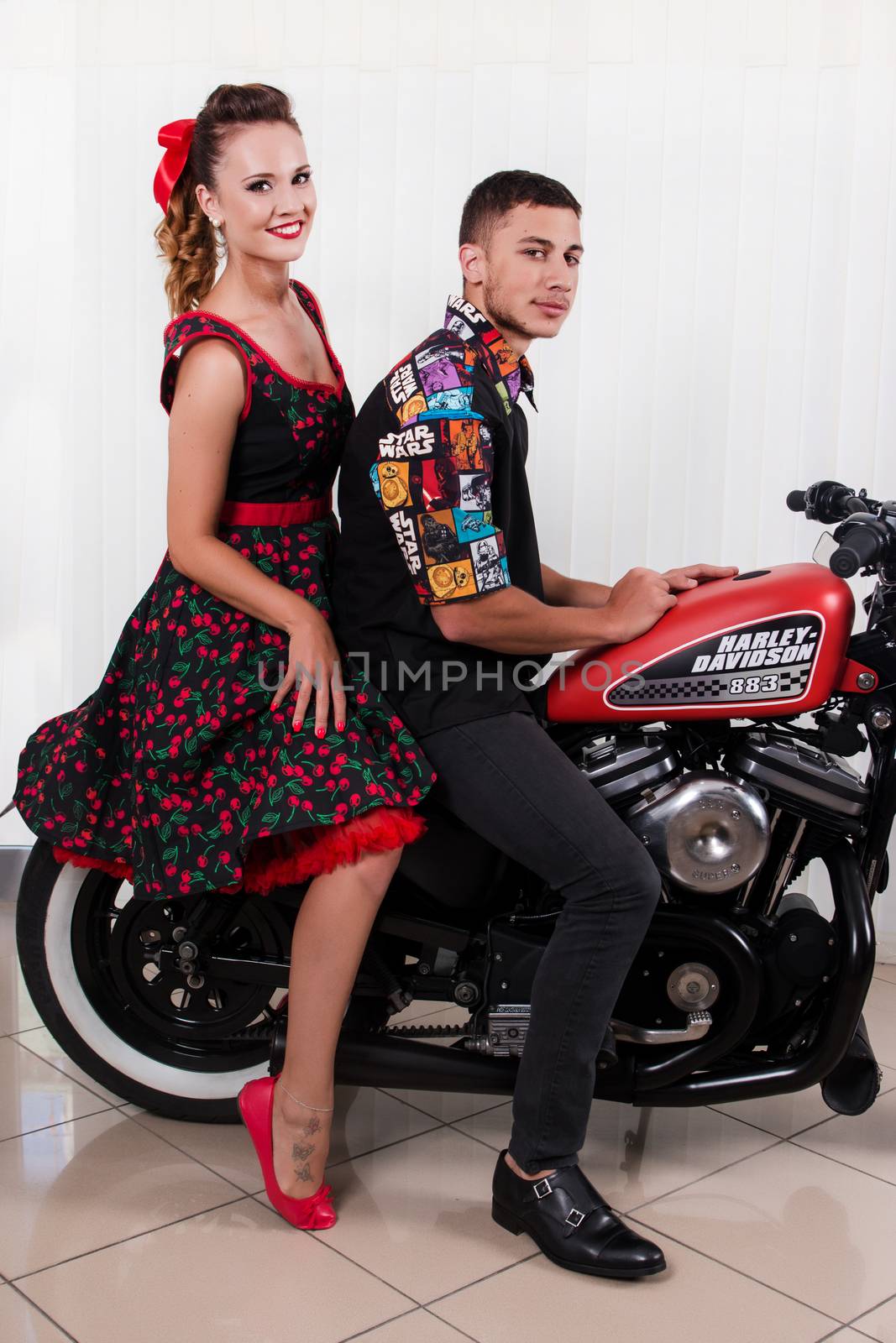 Close up of a couple using vintage clothing on a motorbike.