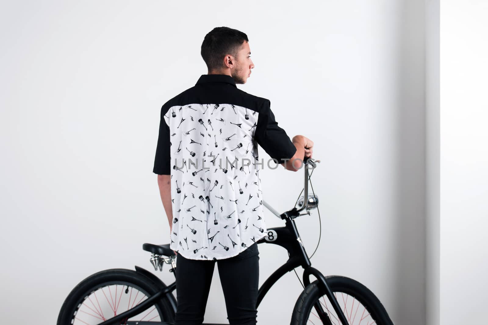 Teenager posing with a vintage style retro clothing and a bike.