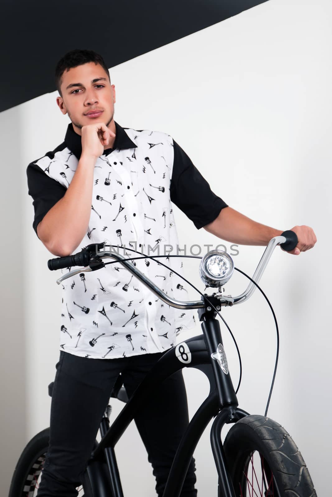 Teenager posing with a vintage style retro clothing and a bike.