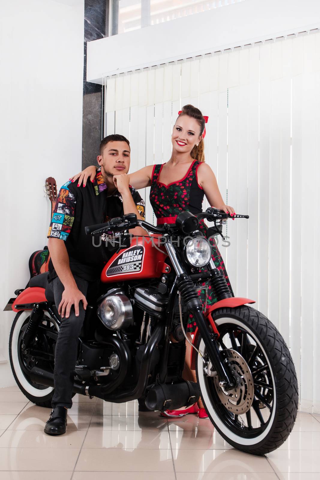 Close up of a couple using vintage clothing on a motorbike.