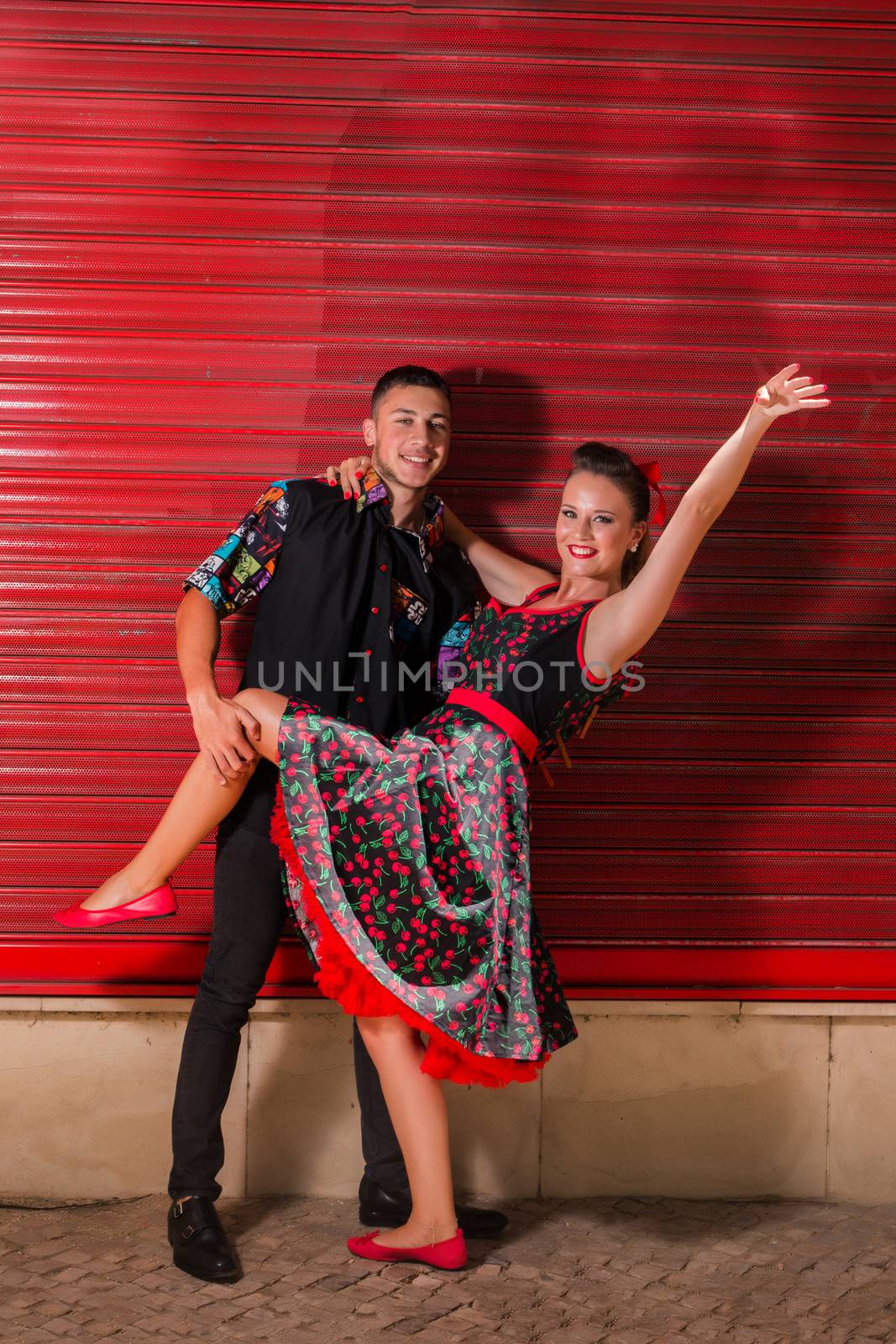 Vintage couple dancing over a red background.