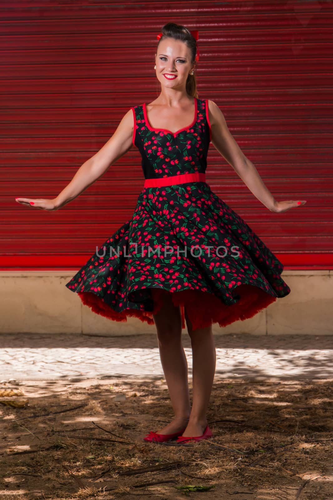 Woman posing with a vintage style retro floral clothing.