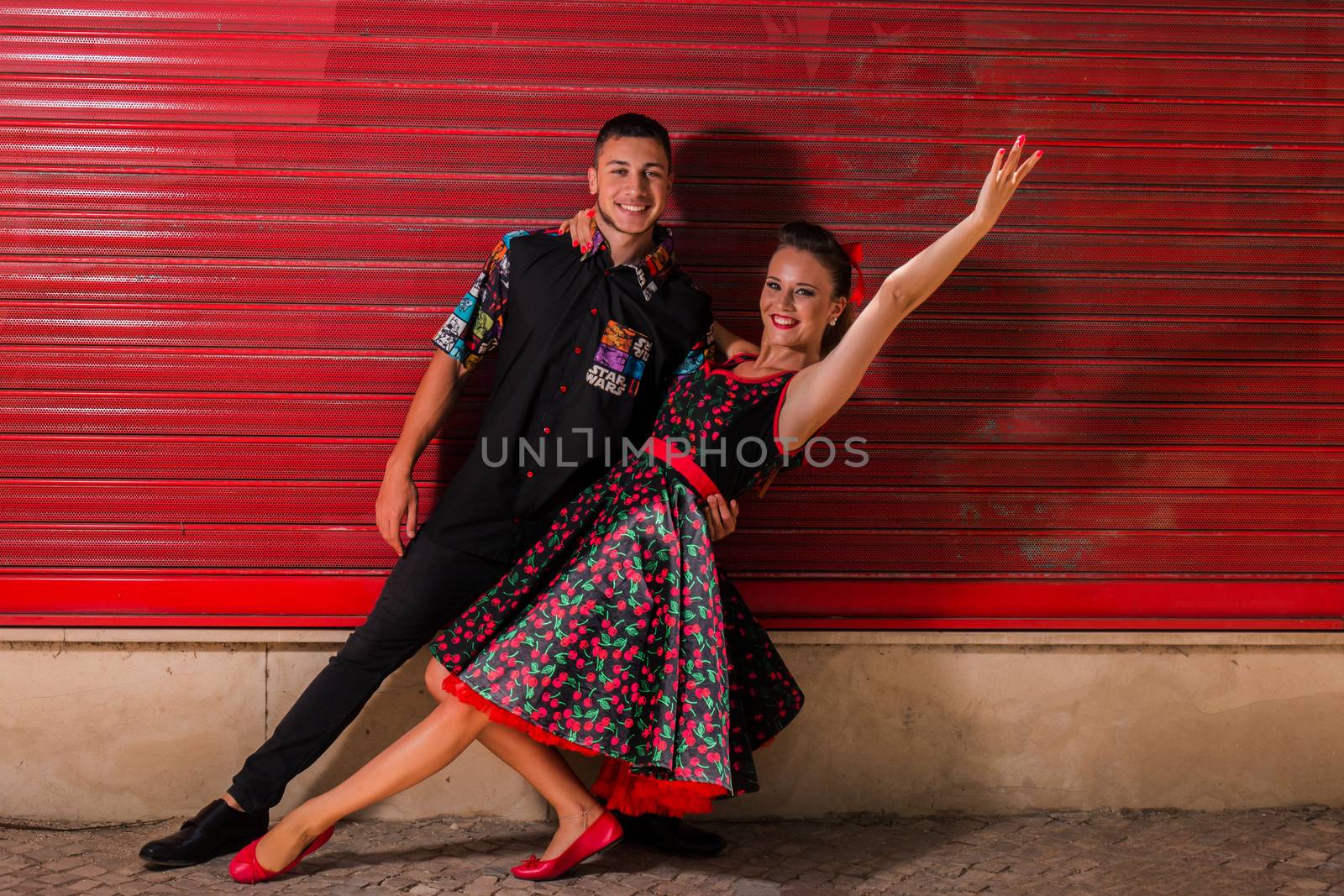 Vintage couple dancing over a red background.