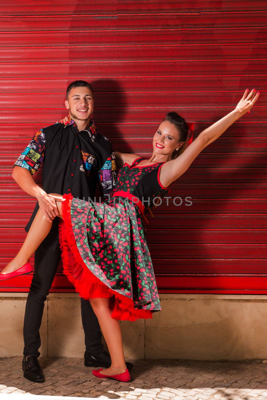 Vintage couple dancing over a red background.