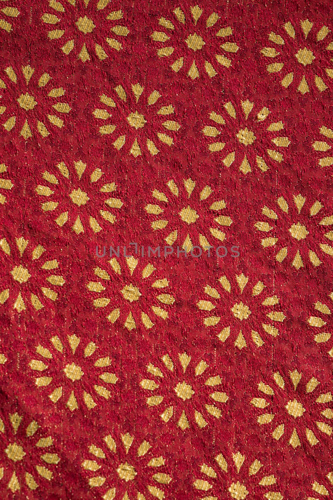 Close up view of Traditional red  and golden medieval fabric design.