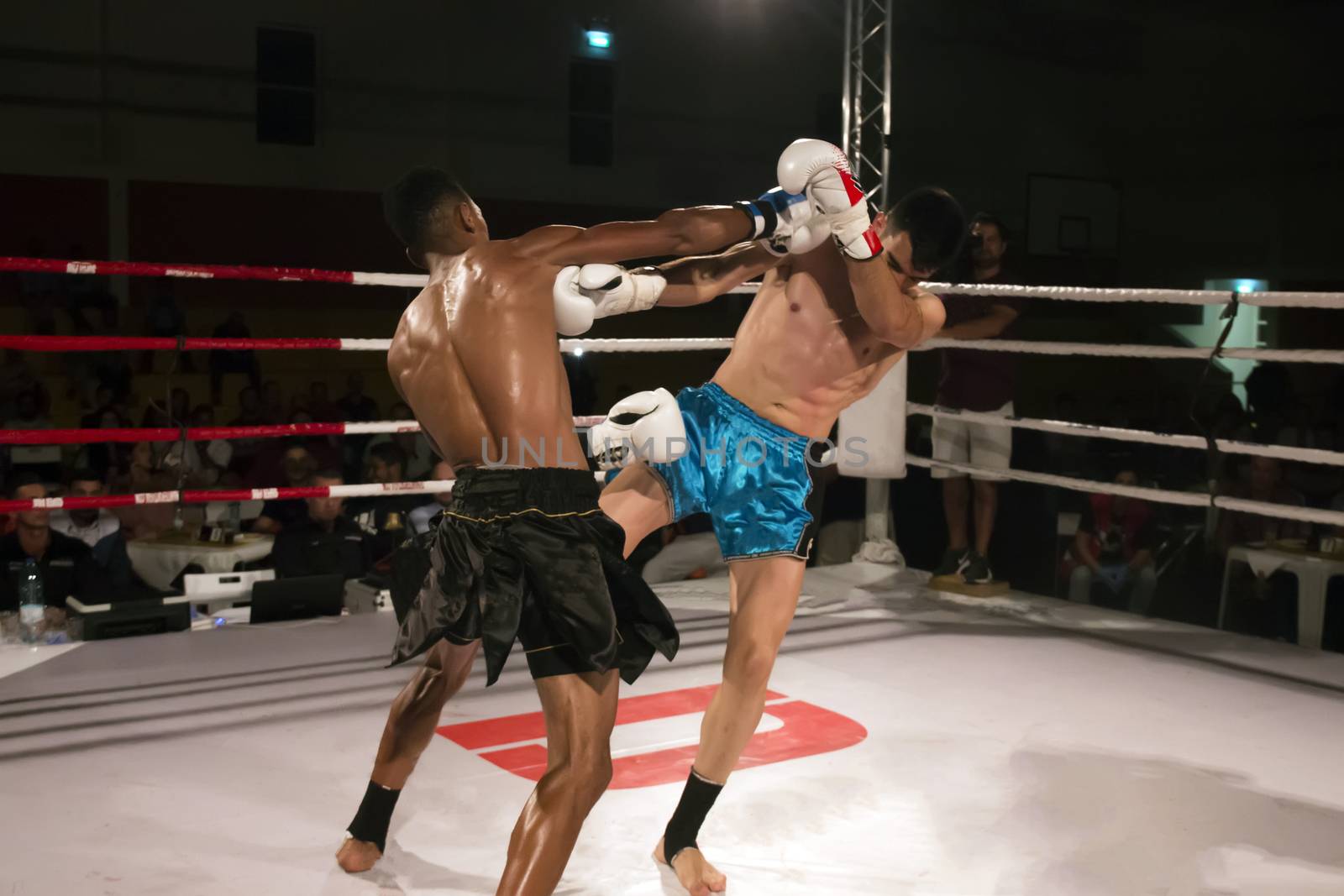 Kickboxer in the ring fighting another athlete.
