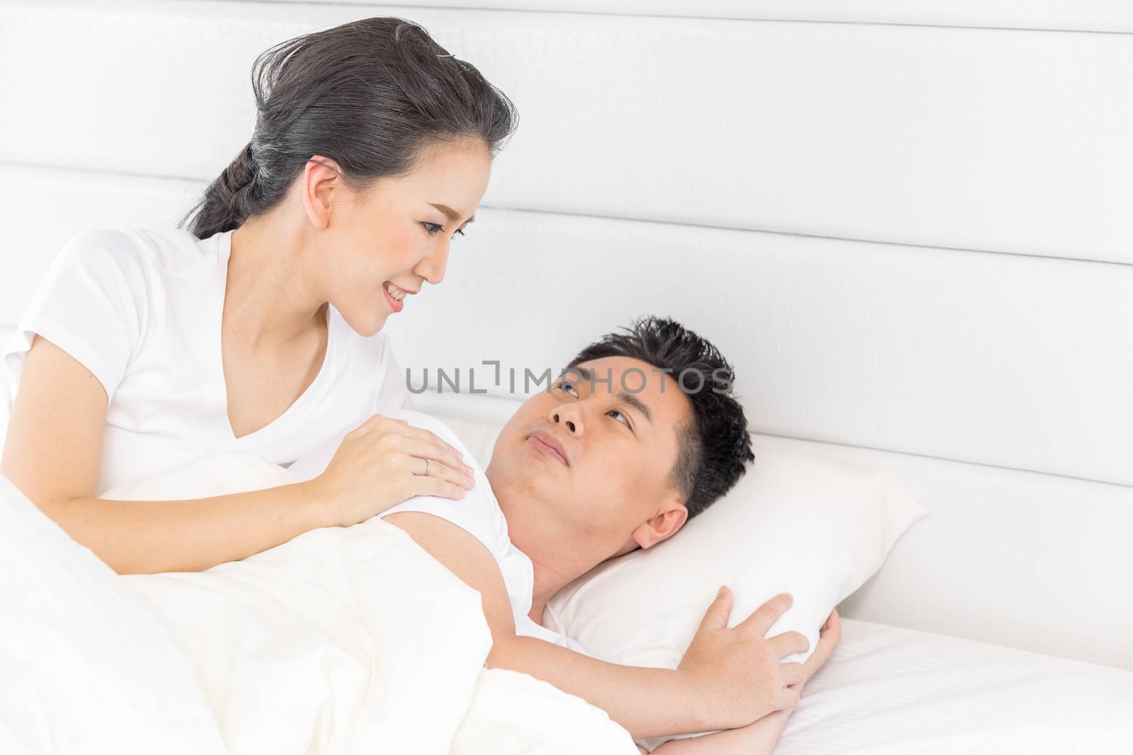 Young loving couple in the bed. Modern lifestyle concept