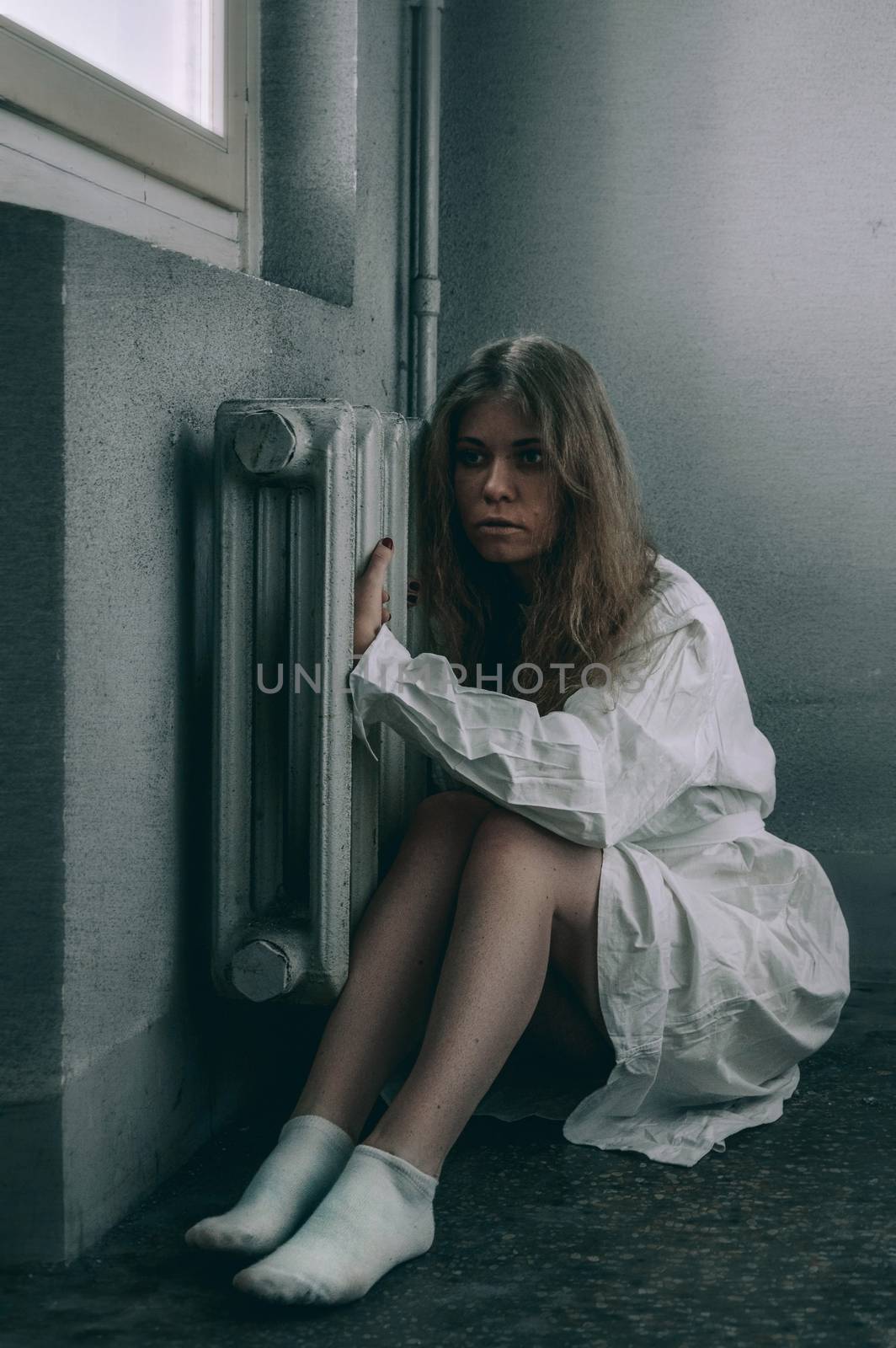 mentally ill girlwith a straitjacket in a Psychiatric