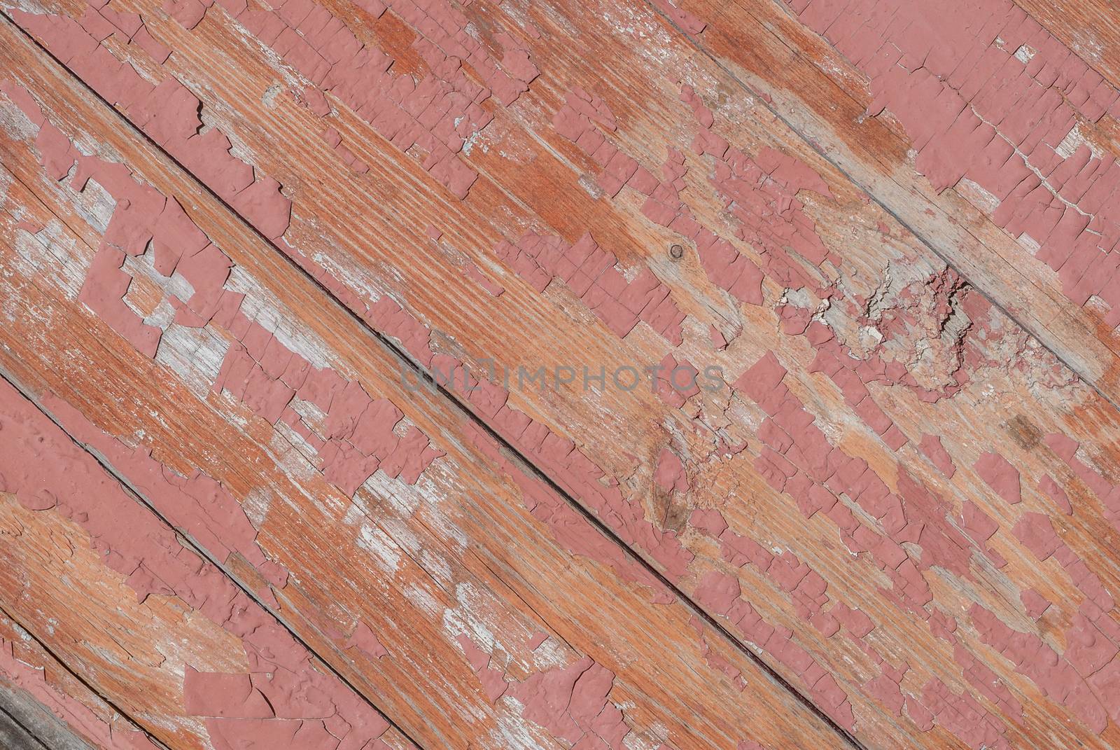 texture of wooden surface with remnants of old paint that has dried and cracked under the influence of weather