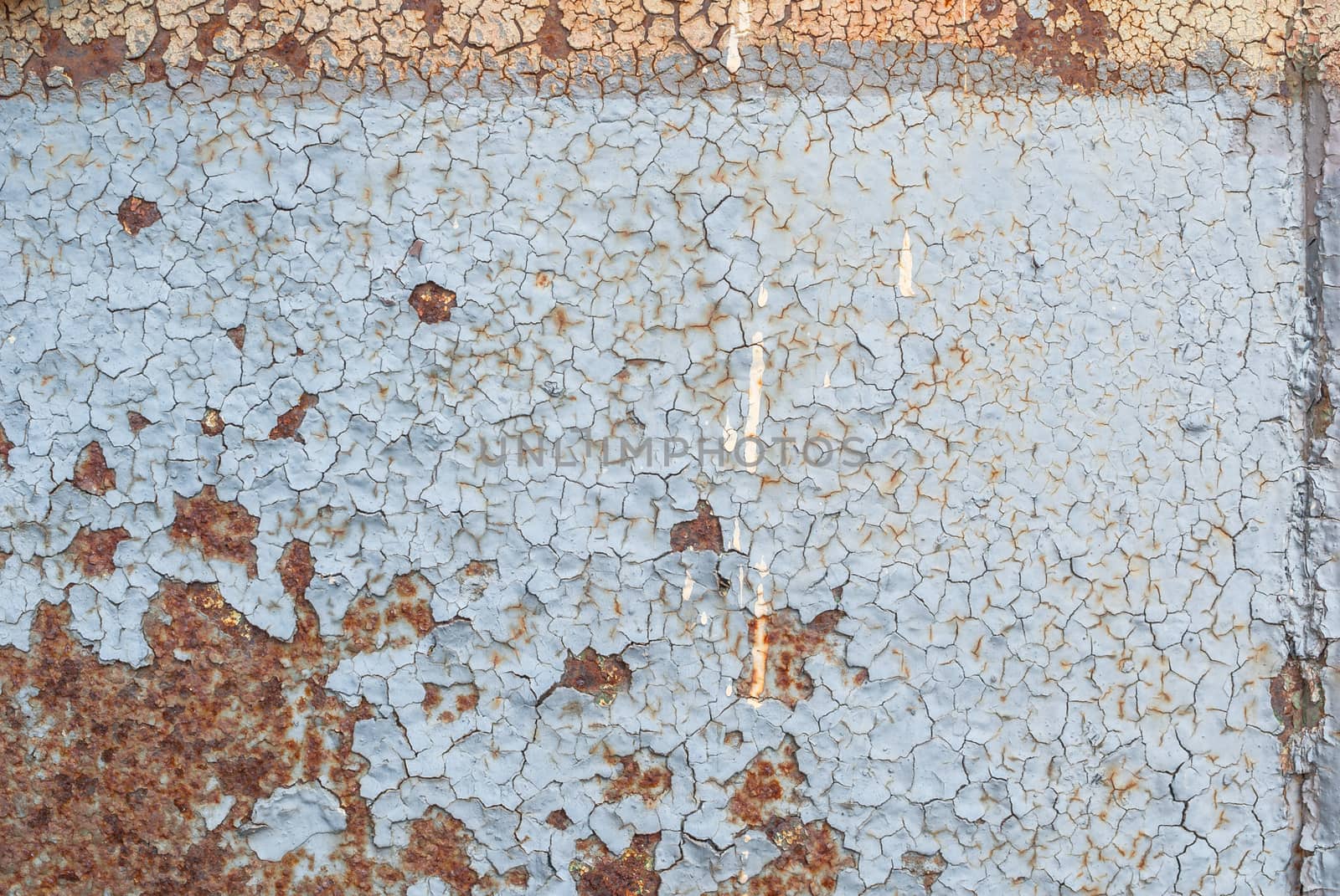 surface of rusty iron with remnants of old paint, chipped paint, texture background by uvisni