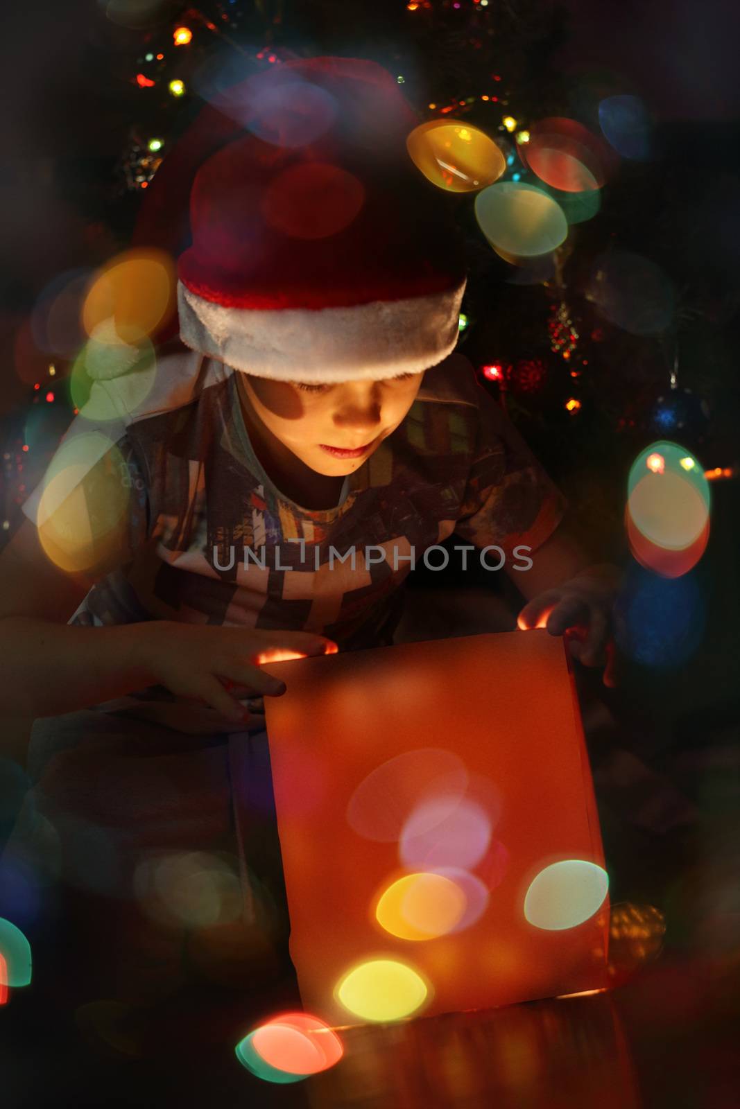 Boy with christmas gift by destillat