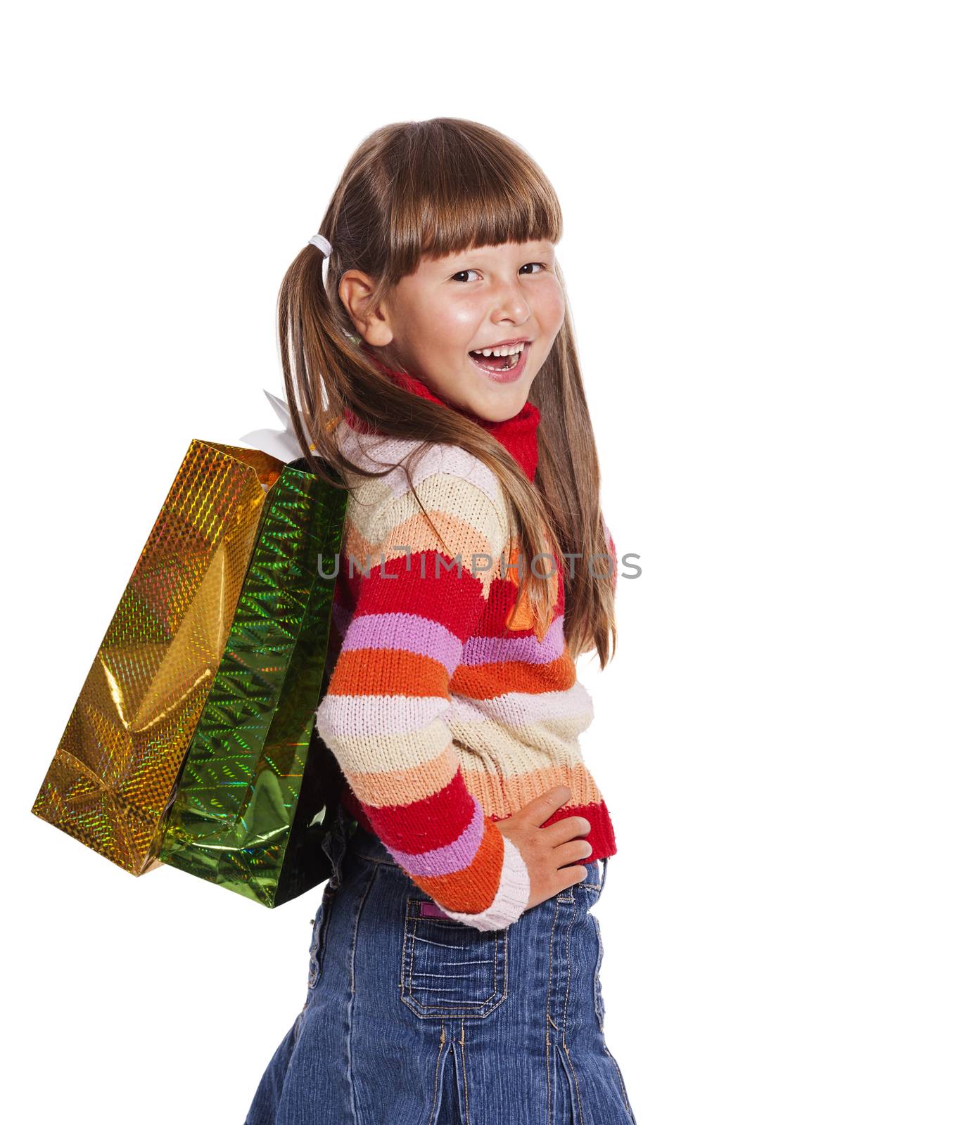 Smiling six years Girl holding presents bags isolated