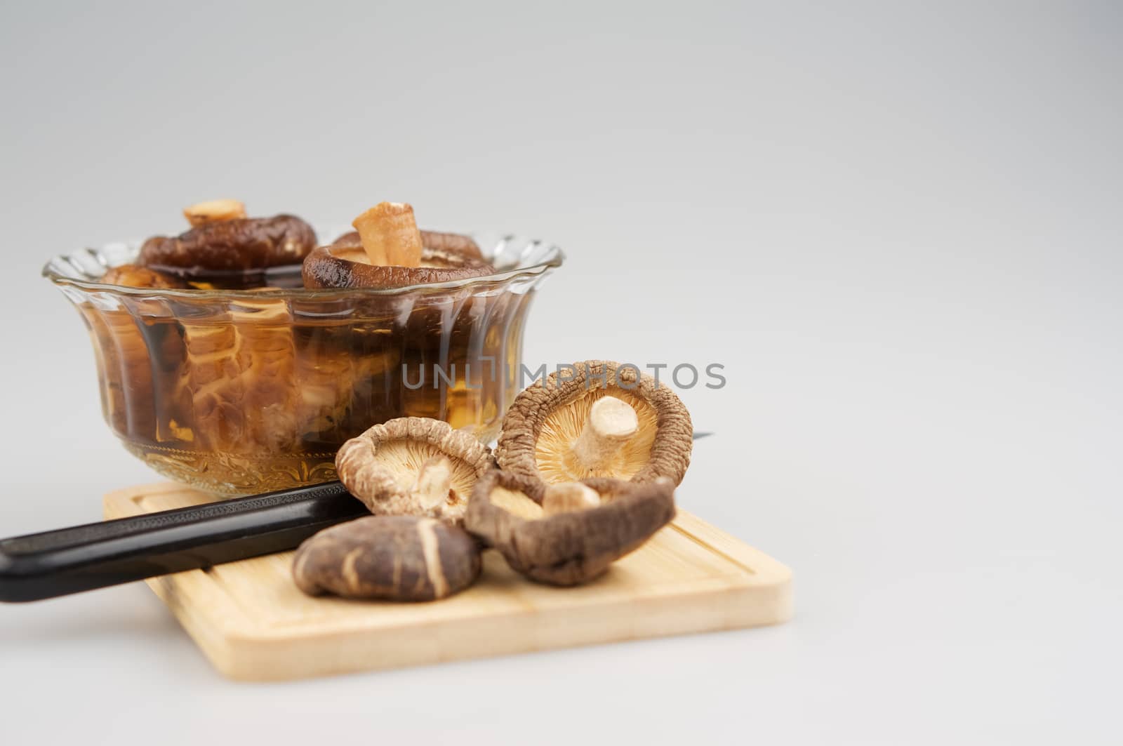 Shitake mushroom, soak mushroom in bowl and knife on chopping board by ninun