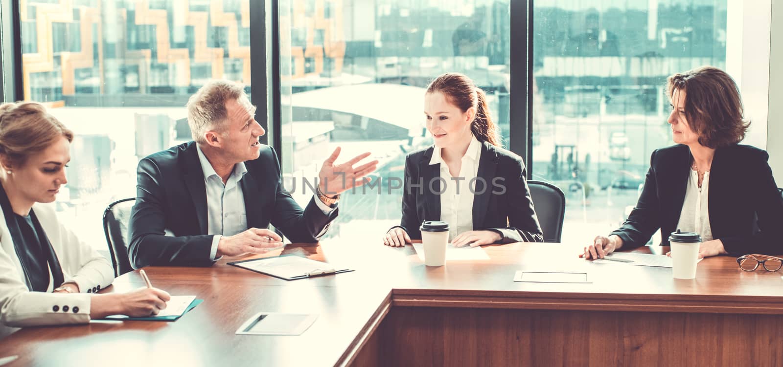 Business partners discussing documents by ALotOfPeople