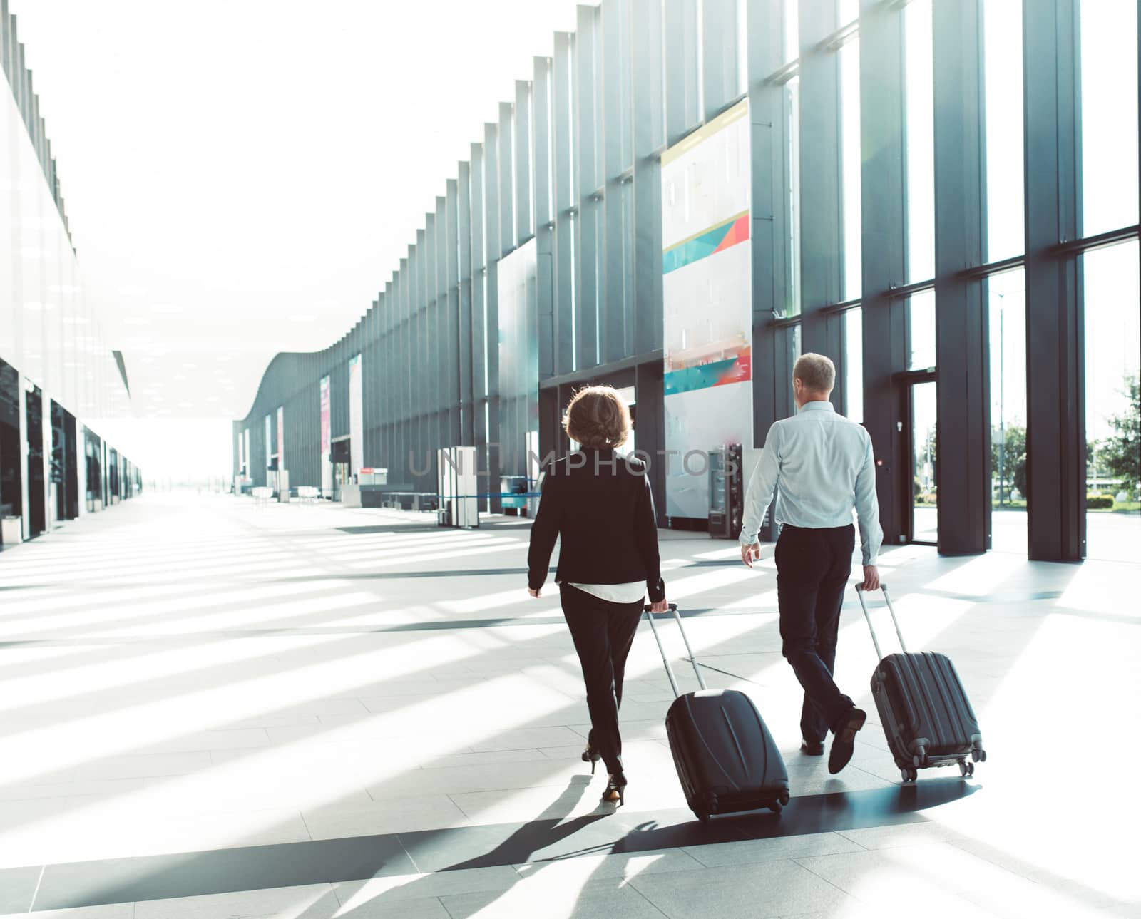 Business people walking in airport by ALotOfPeople