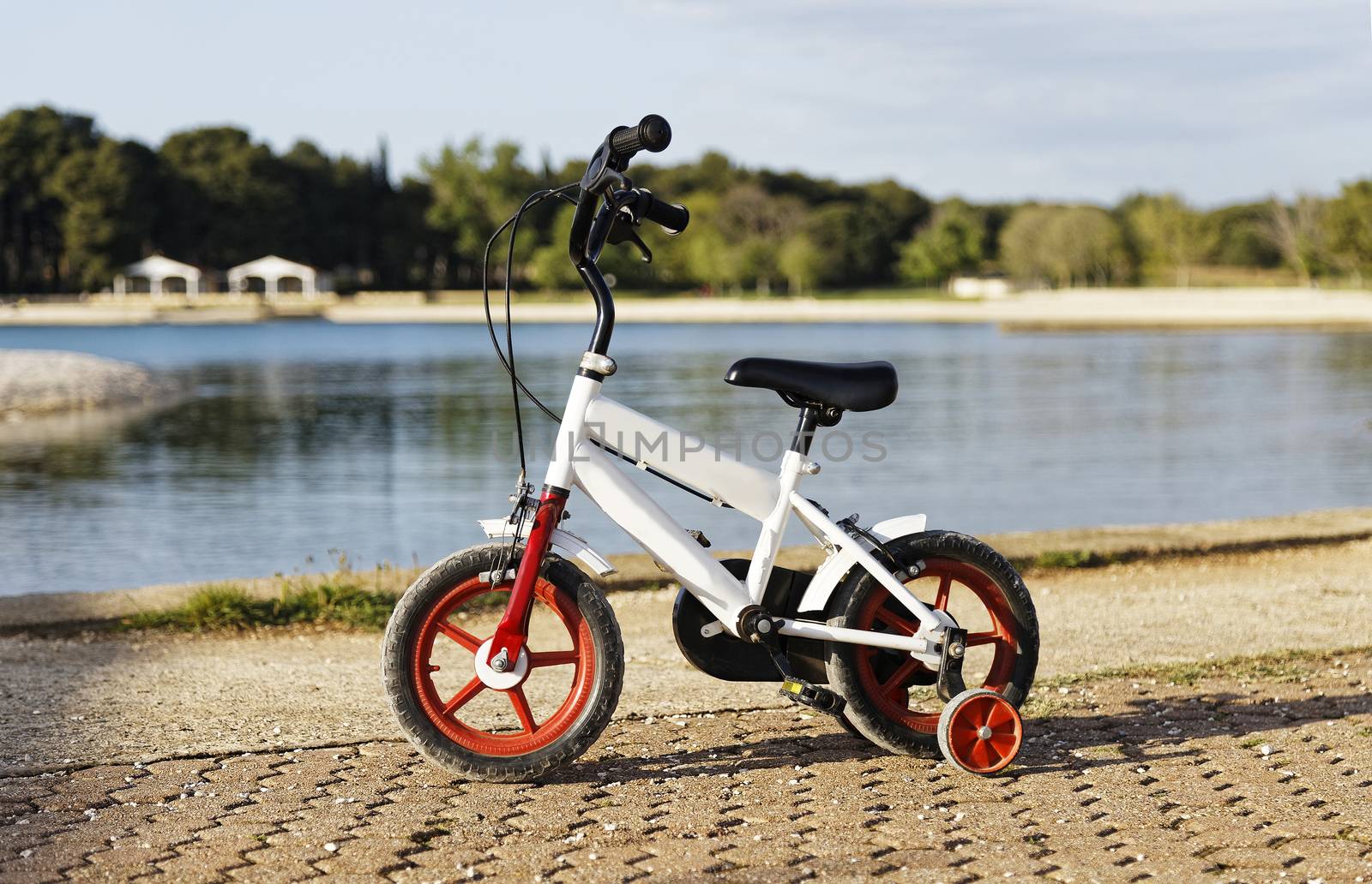 children's bike standing on the promenade near the sea