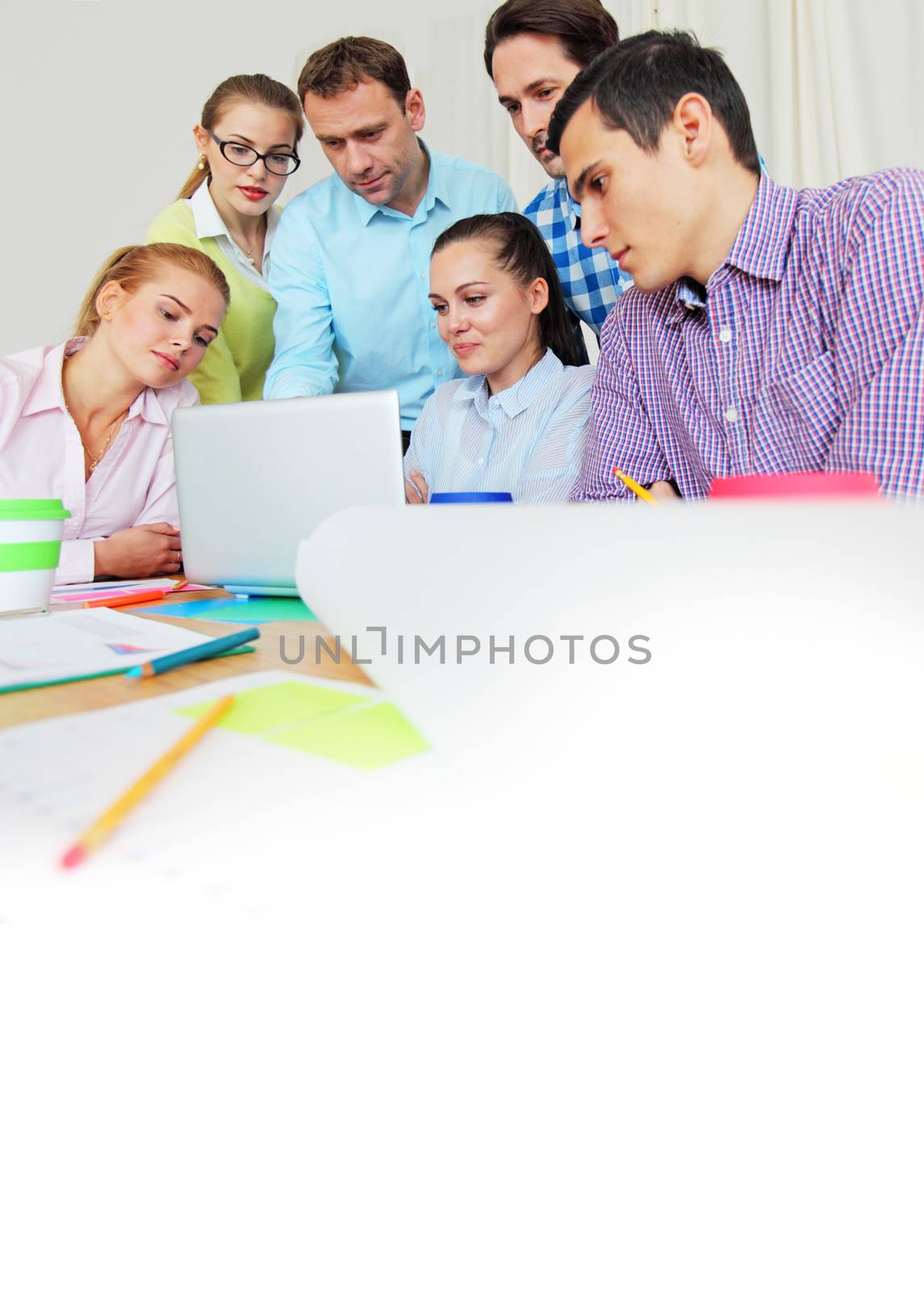 Business team work together looking at one laptop at workplace
