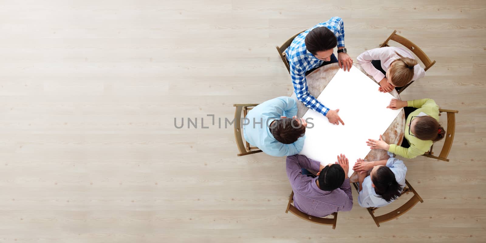 Hipster business teamwork brainstorming planning meeting concept, people team sitting around the table with white paper and pointing, copy space