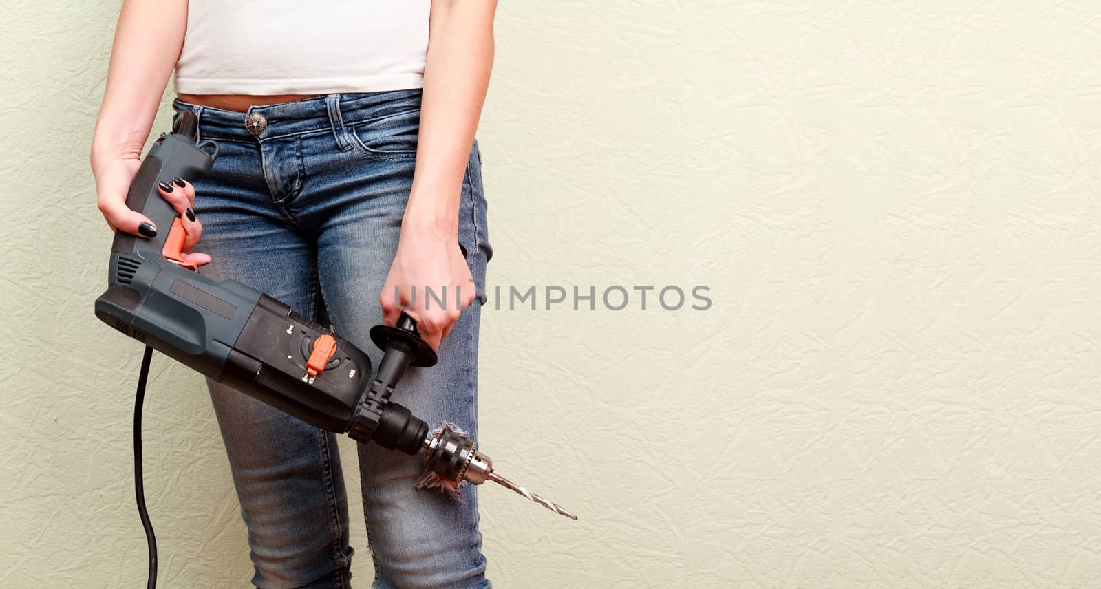 Woman holds a drill