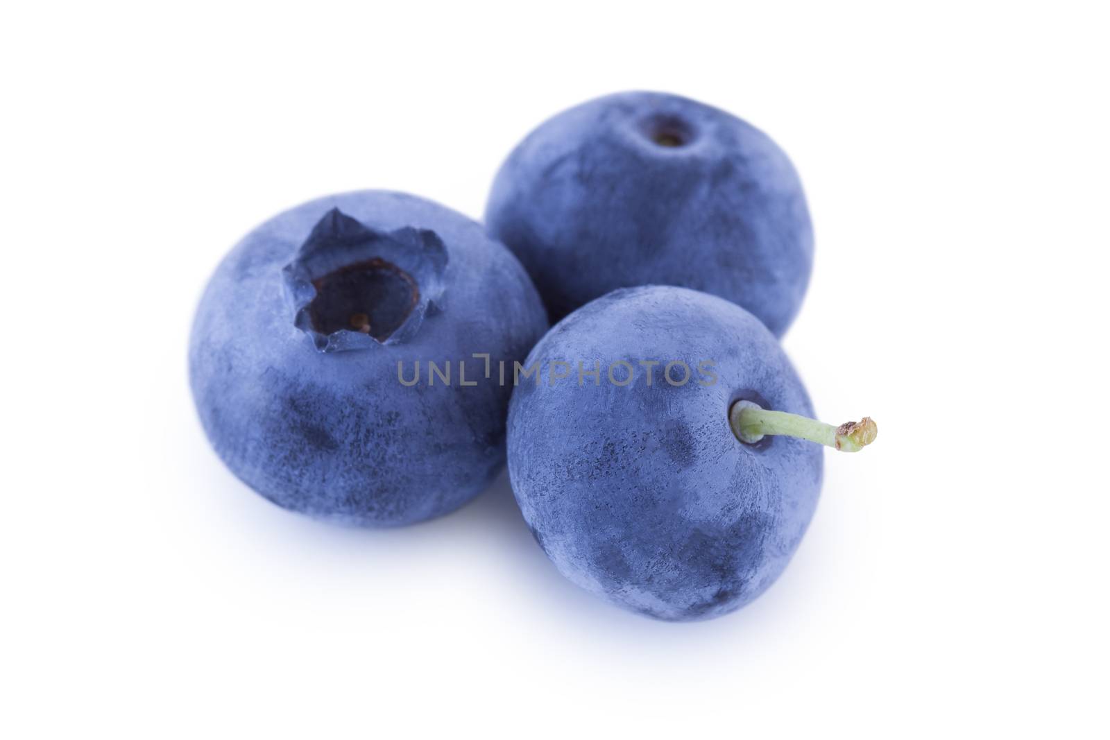 Three blueberries isolated on white background, fruits closeup