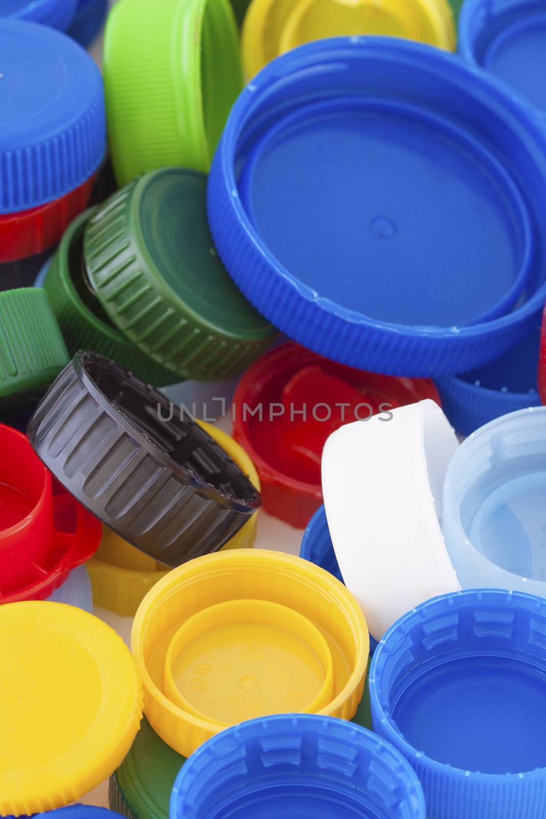 Colorful plastic bottle caps closeup, recycled garbage