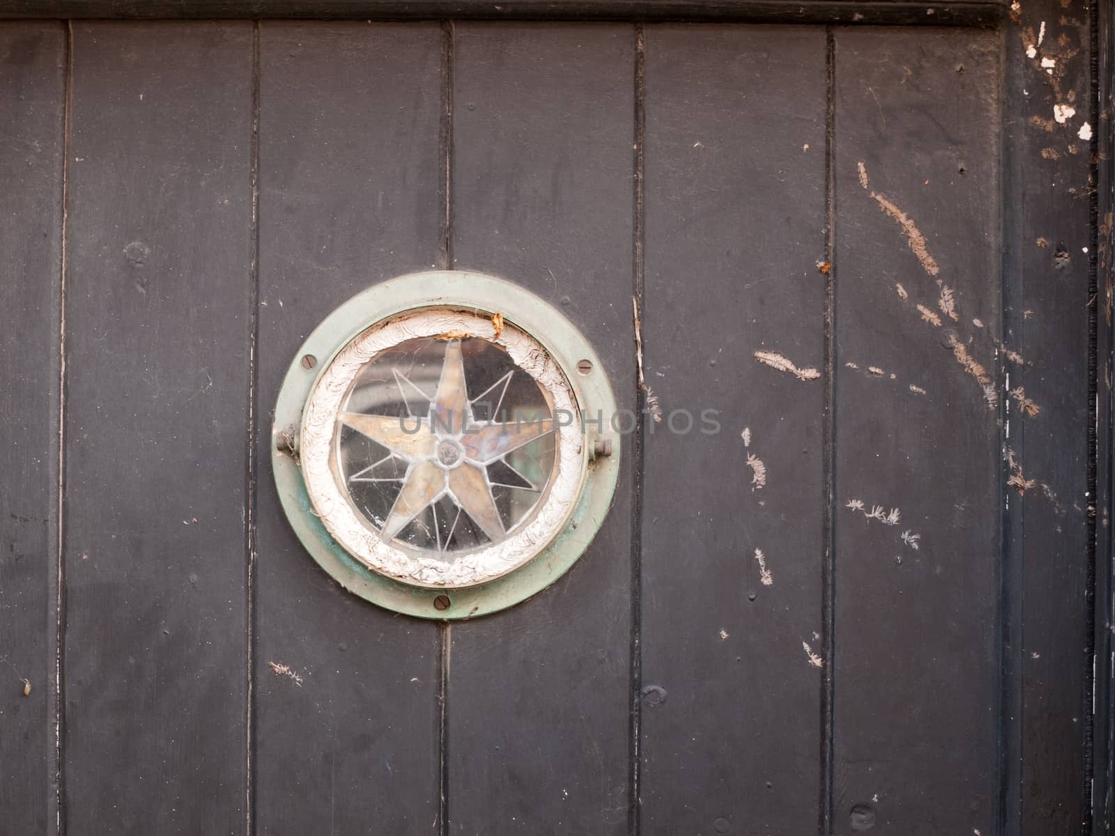 interesting star sign door window vintage rustic; essex; england; uk