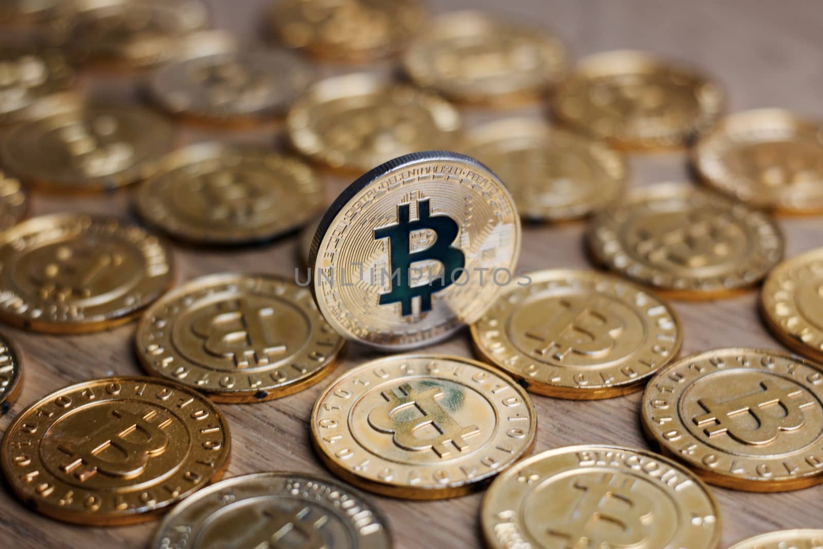 Digital currency physical metal bitcoin coin on the gold money background. Money concept.
