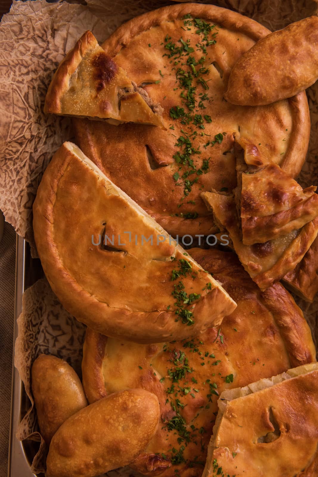 Different pies from meat and vegetables. Freshly baked cakes on a table