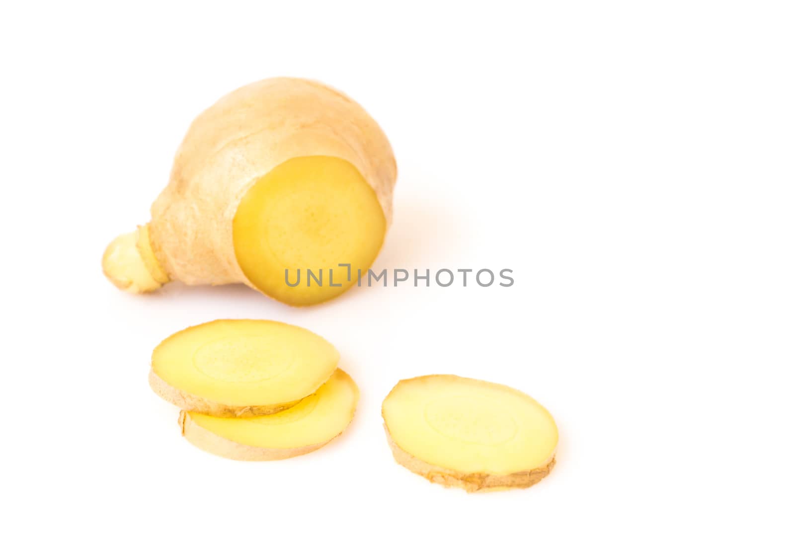 Fresh ginger with slices on white background for herb and medical product concept, selective focus