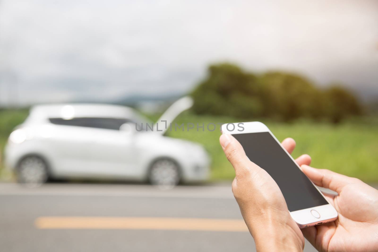 Broken car, man is using a phone to call the car mechanic