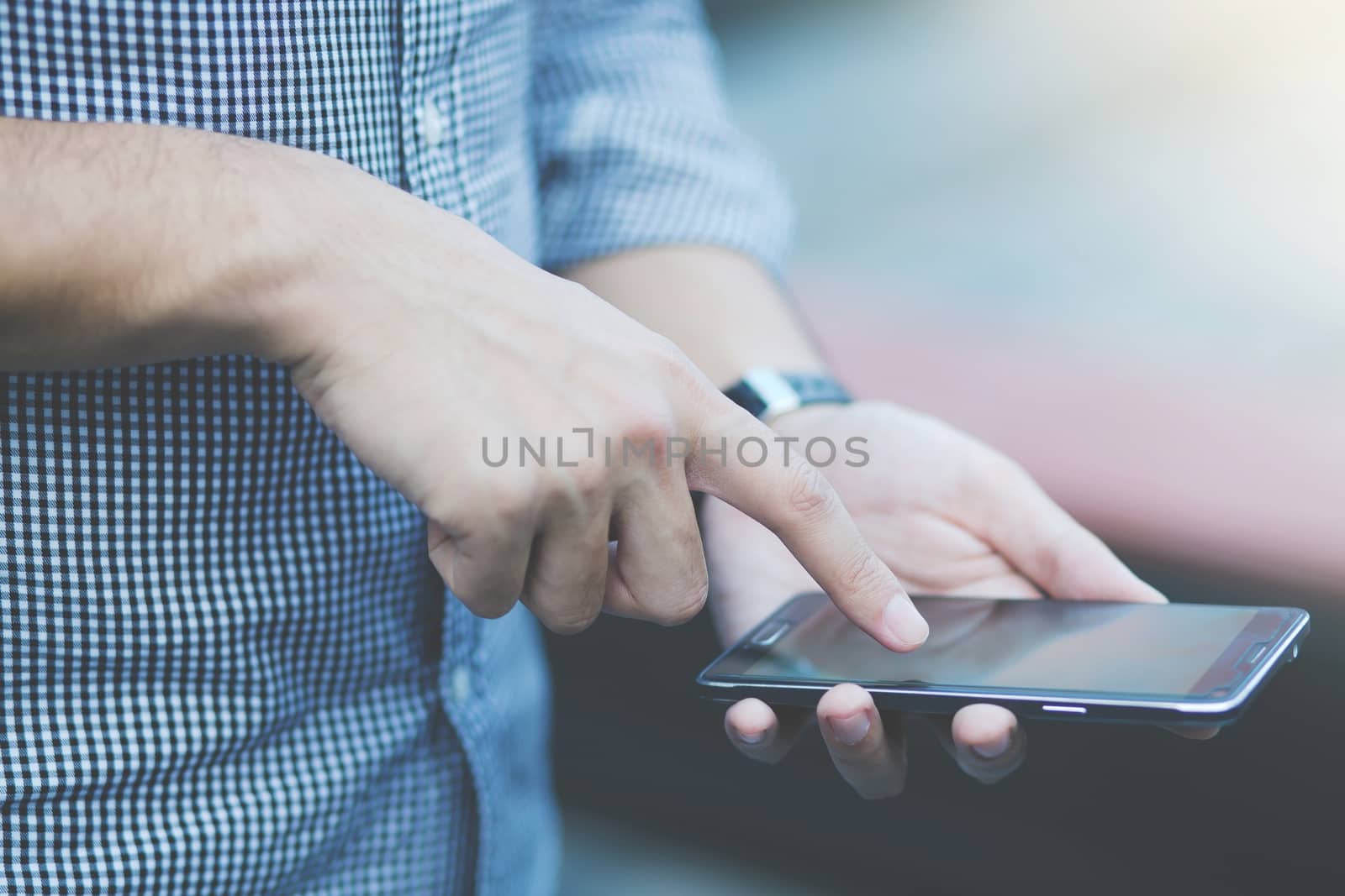 Young Man using mobile smart phone.