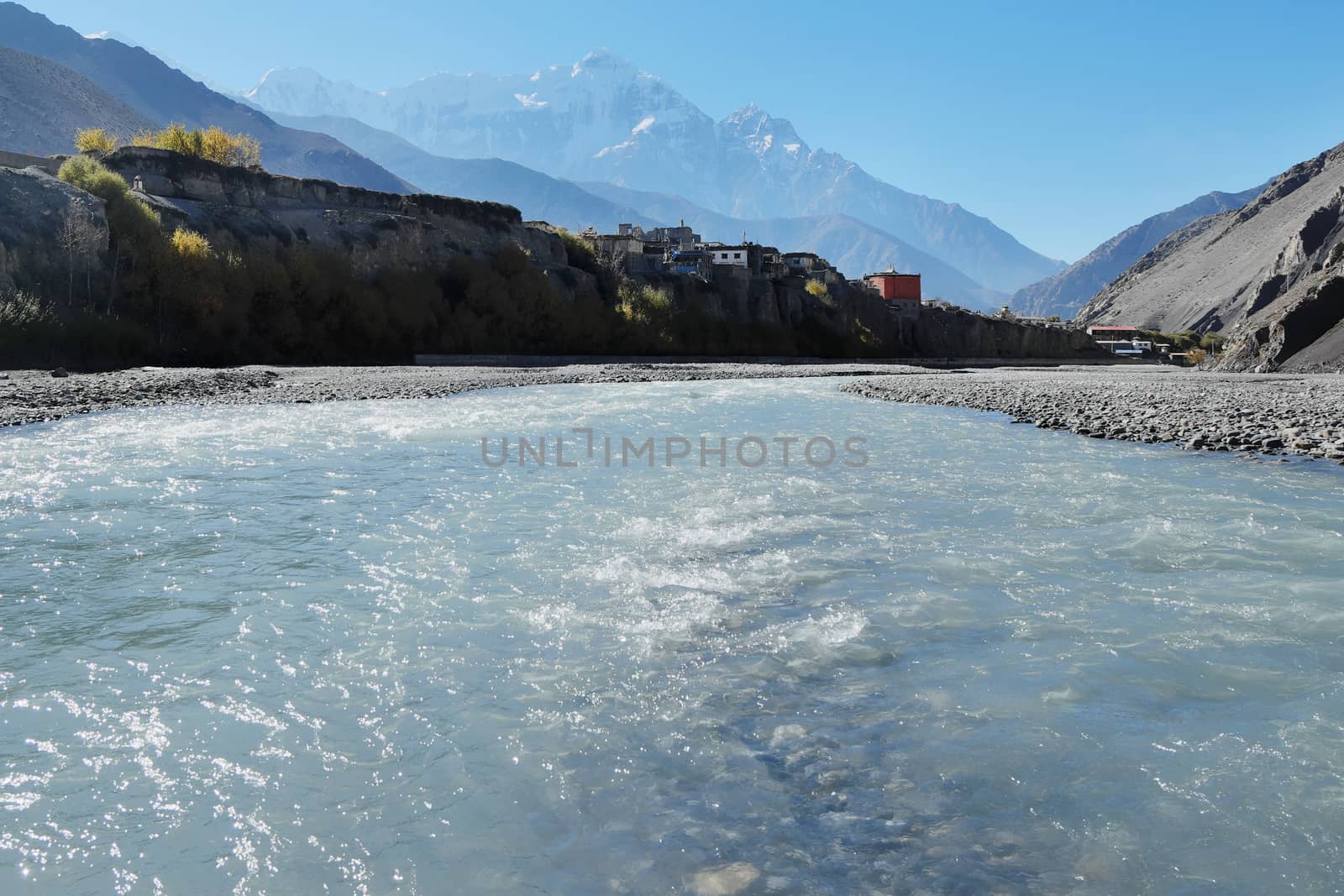 Mountain river in the Himalayas with the eight-thousand-meter Dhaulagiri in the background