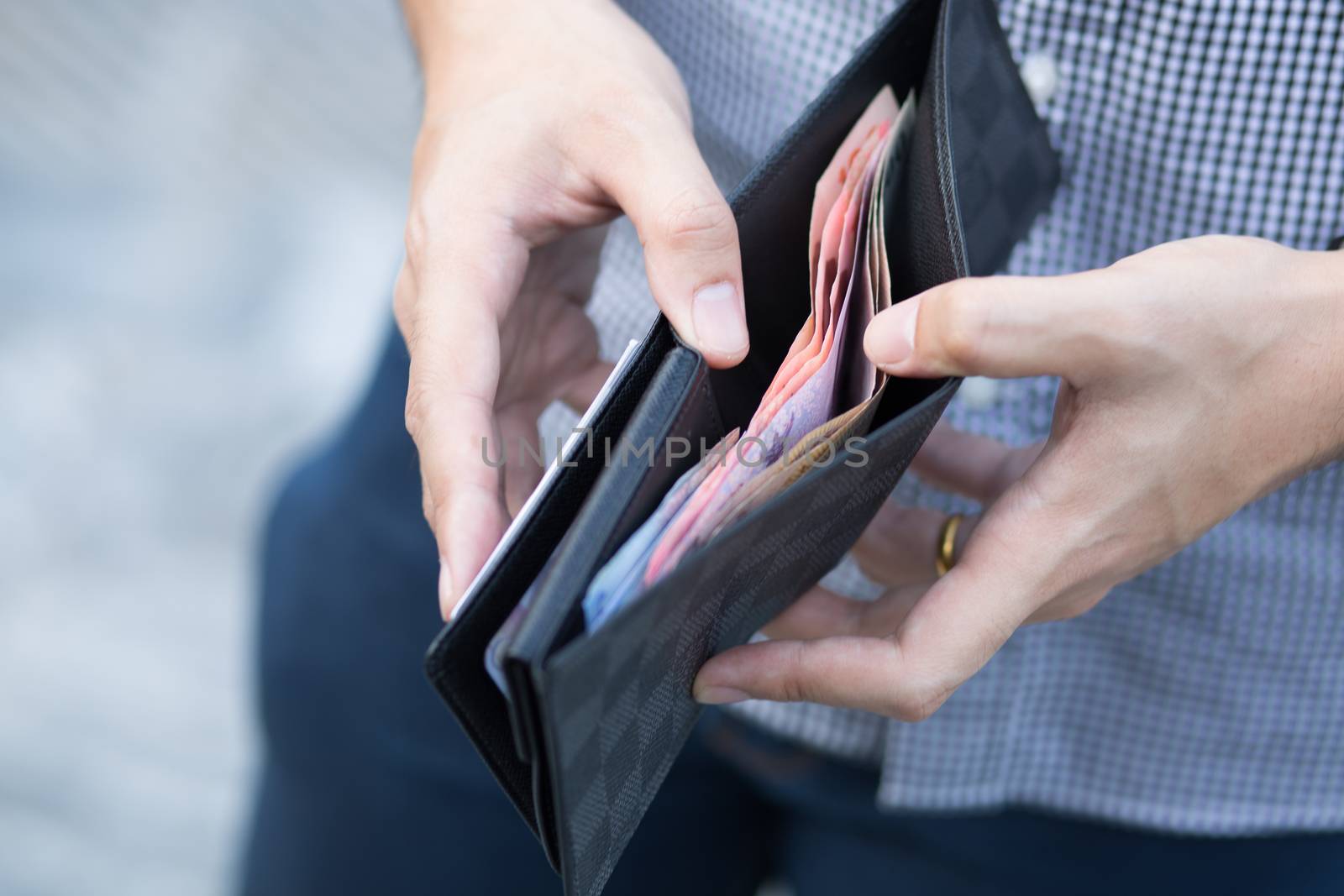 Man holding a wallet with money