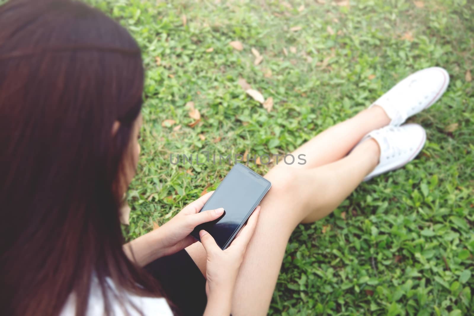 Student young woman using telephone in the parks.