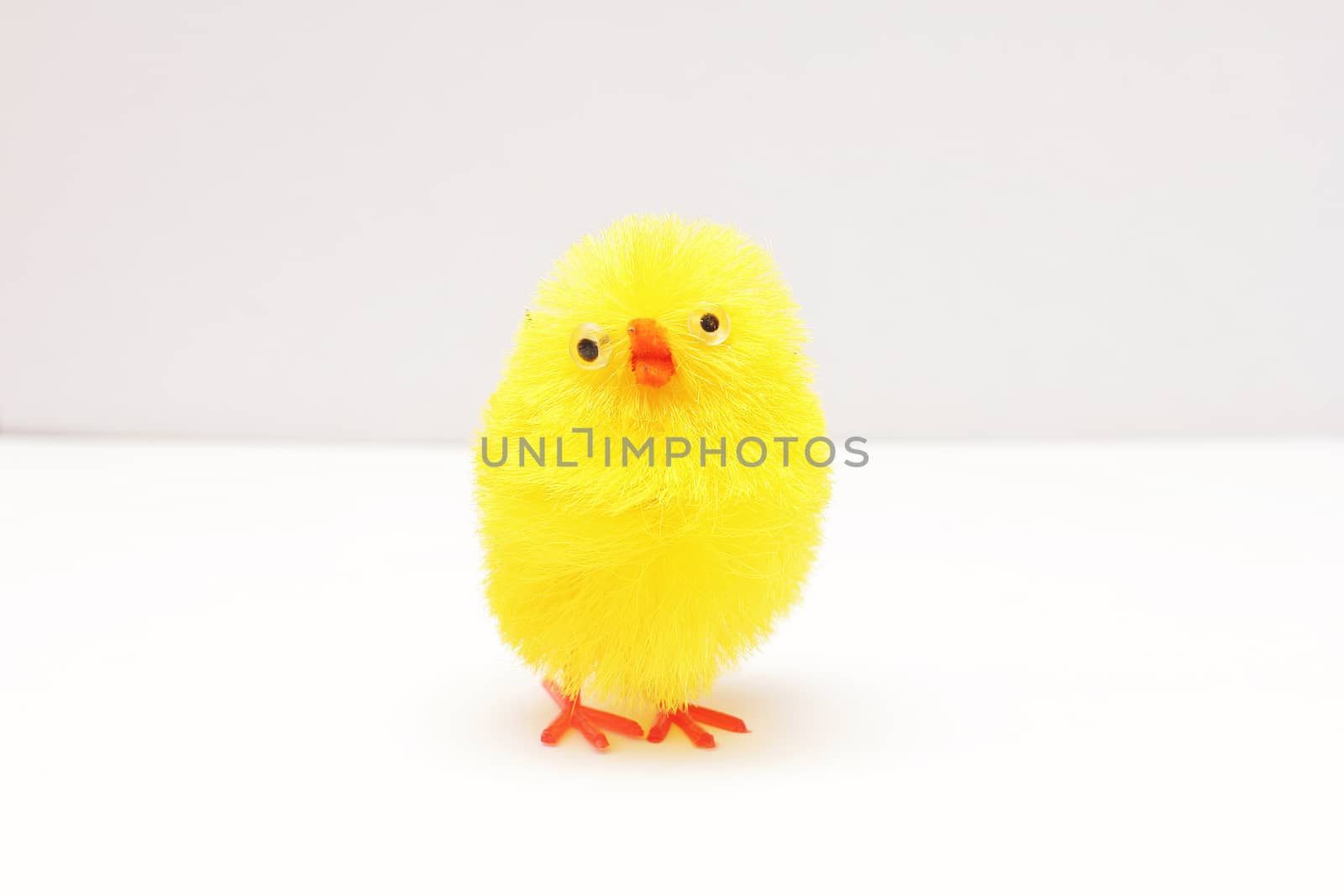 Toy little funny chicken on a white background.