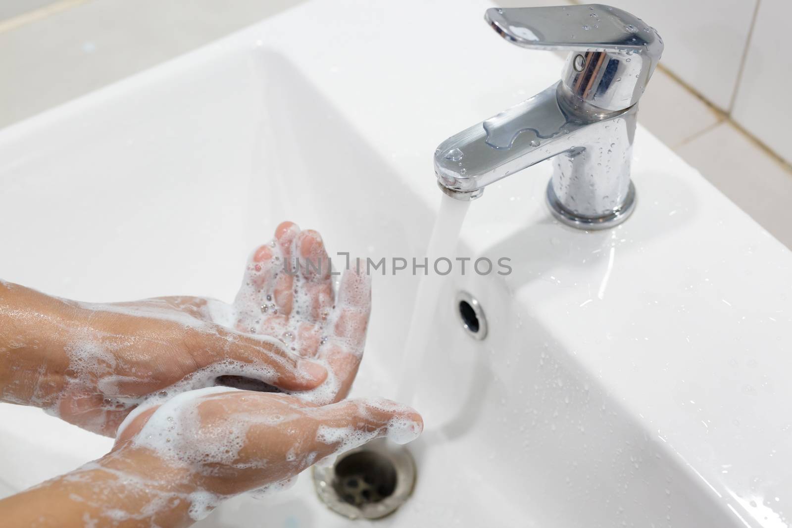 Hygiene. Cleaning Hands. Washing hands with soap under the faucet with water Pay dirt.