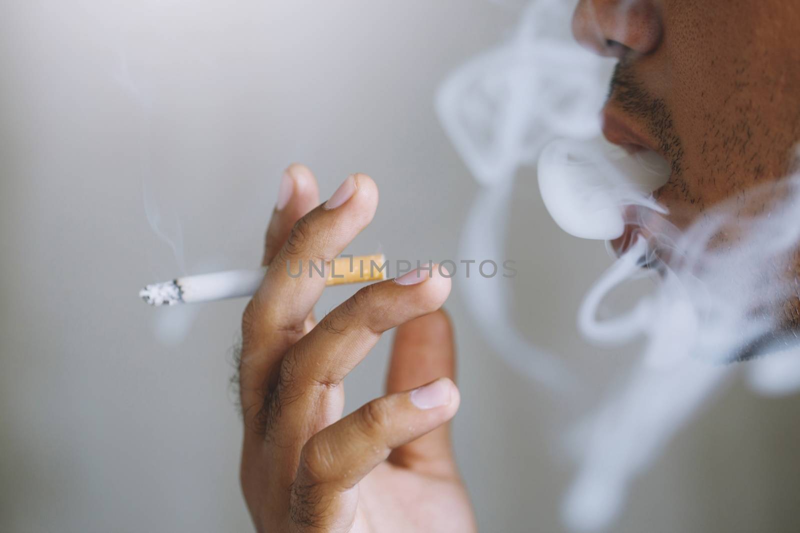 a young man smoking a cigarette by boytaro1428@gmail.com