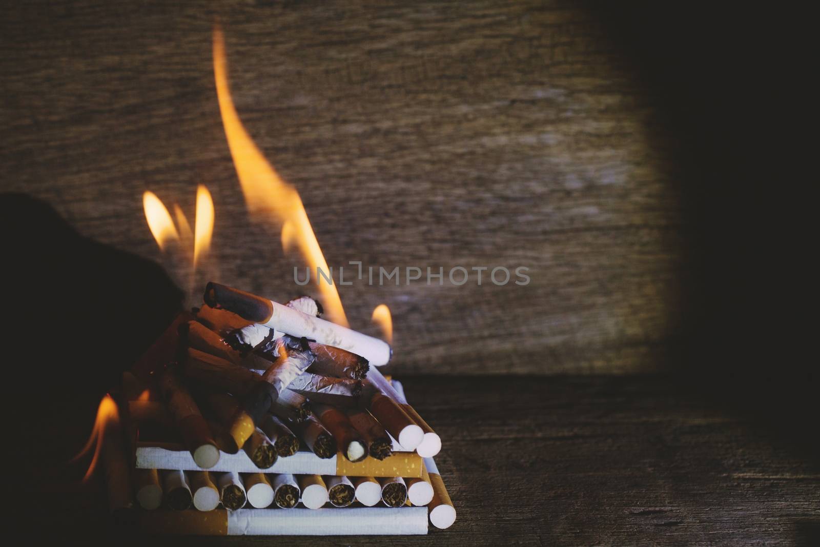 burning cigarette In the wood floor. Campaign no smoking concept.