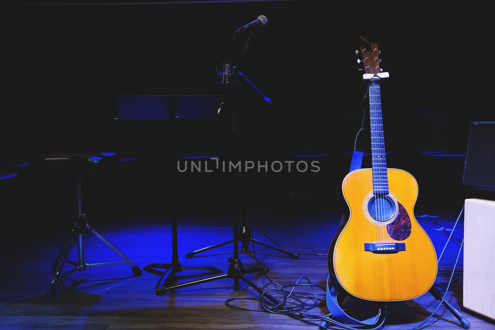 Acoustic guitar. Musical instrument with on stage in Concert. by boytaro1428@gmail.com