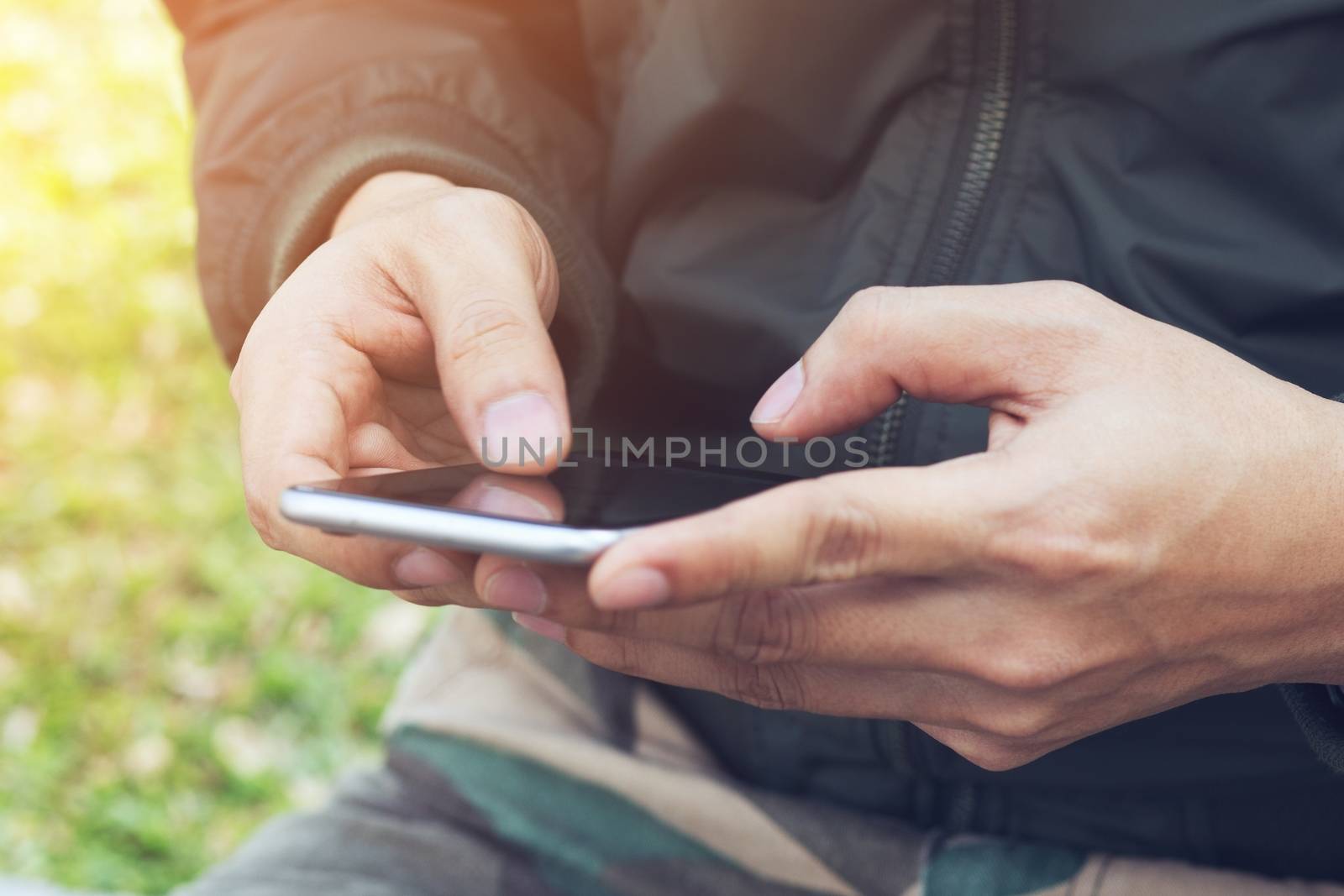 Mid section of military soldier using mobile phone in boot camp. letter from war.