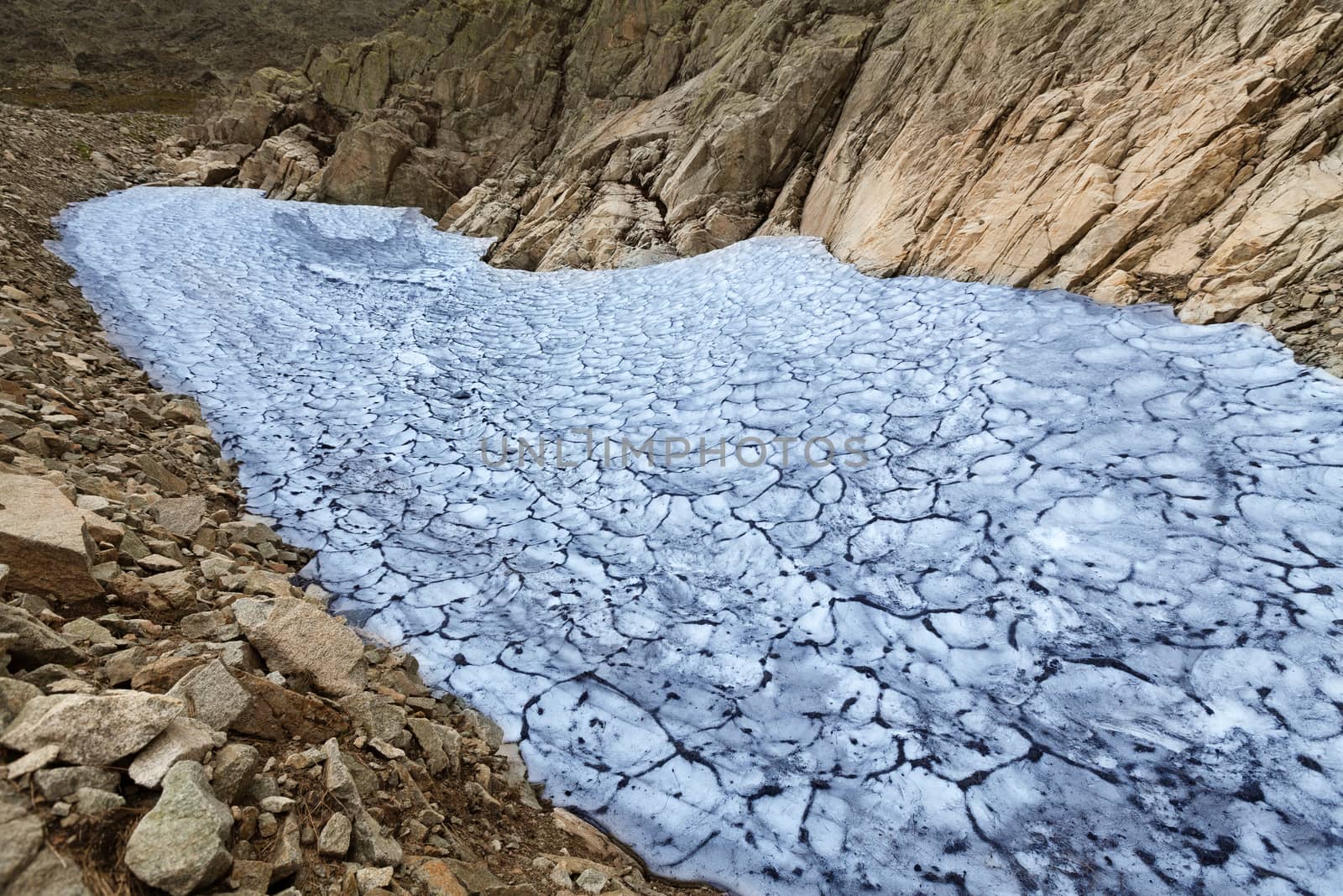 Snow residue on the slopes of the mountain in the summer period