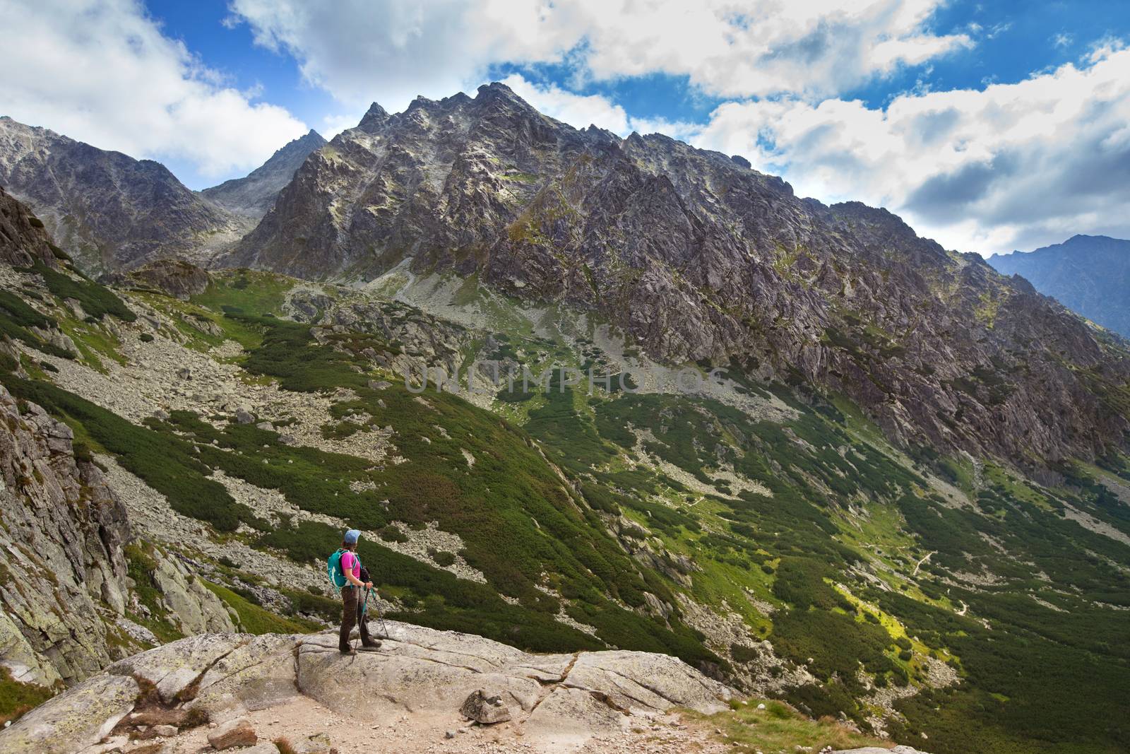 Hiking woman admiring the beauty of rocky Tatra mountains by igor_stramyk