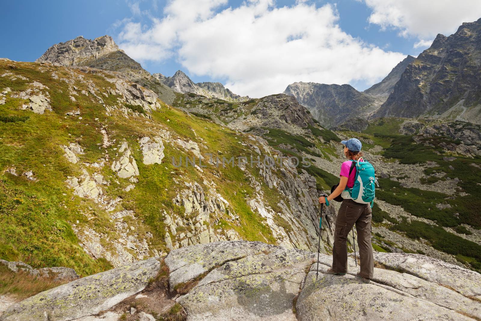 Hiking woman admiring the beauty of rocky Tatra mountains by igor_stramyk