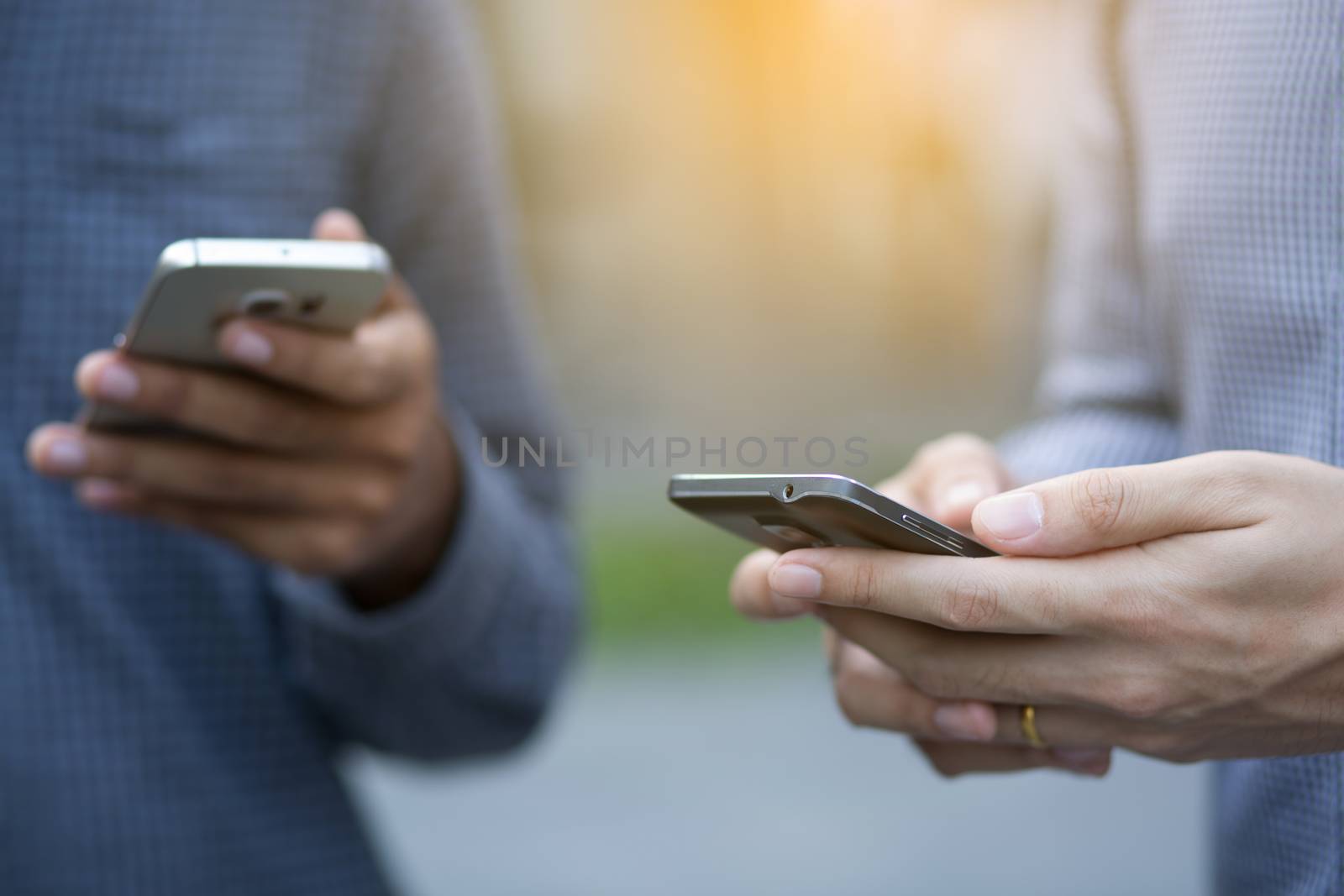 Businessmen use smartphones to contact customers