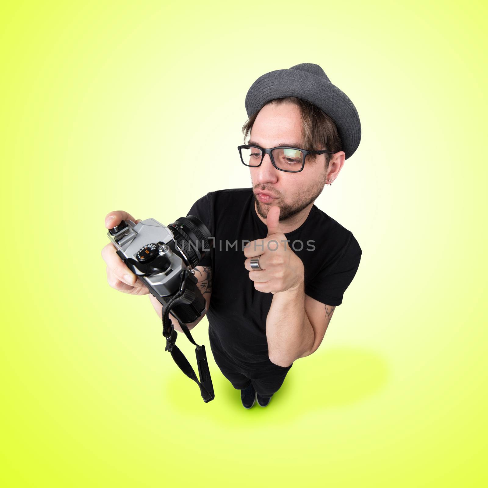 Funny Man with hat and vintage photocamera selfie laugh looks like caricature of himself