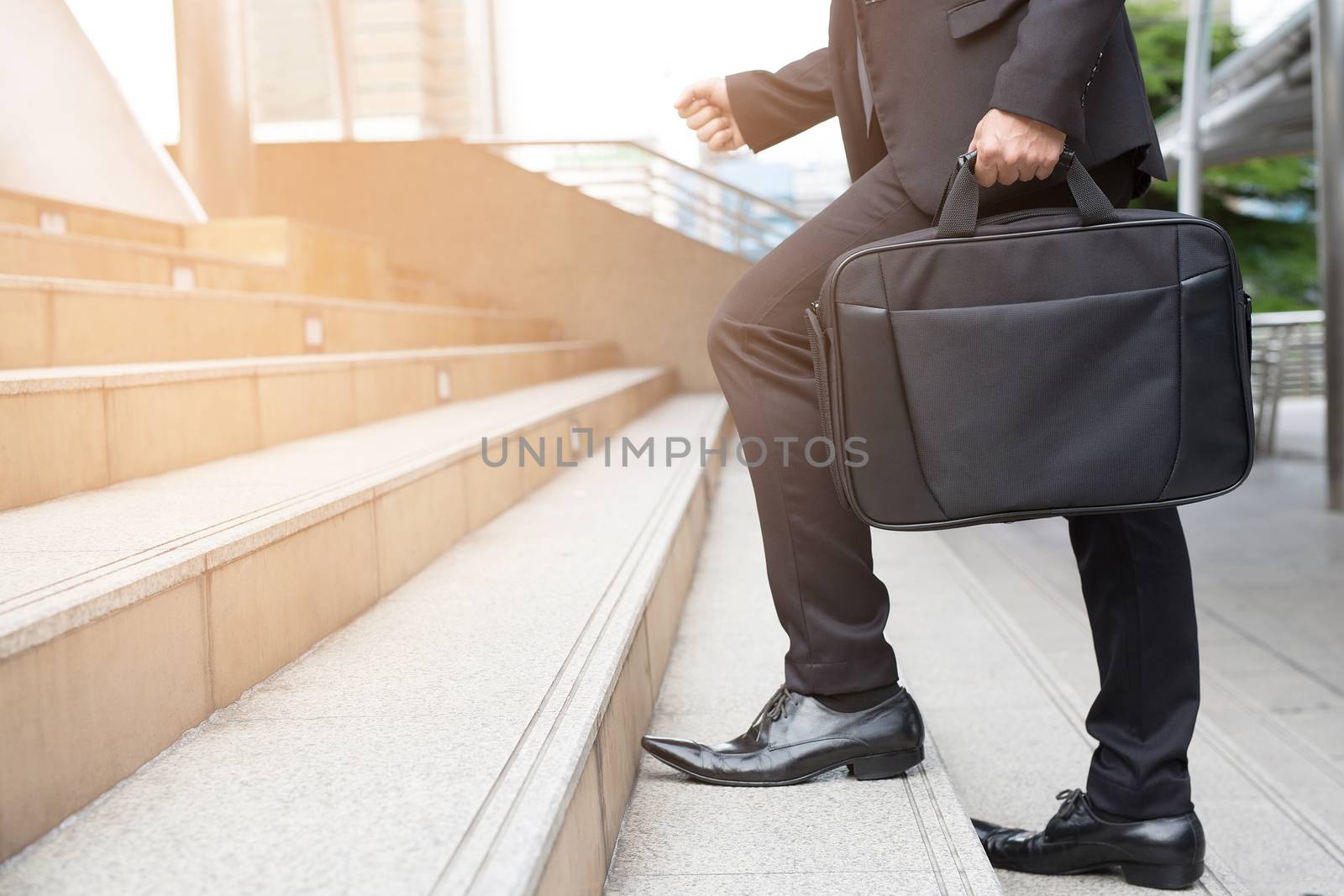 Businessman walking upstairs ,Fighting against obstacles Climb up to Successful finish concept