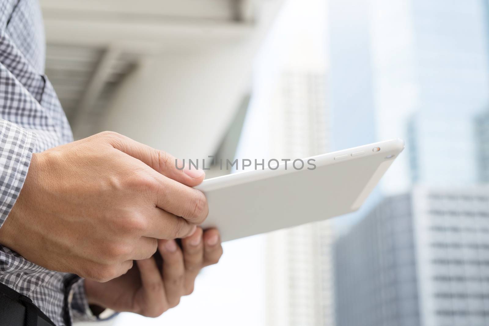 Young businessman using tablet adult working on a digital.