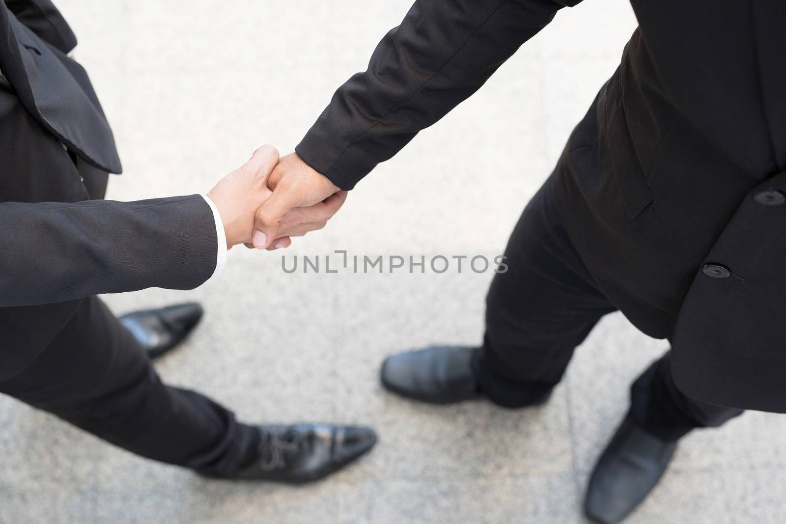 Close Up of a businessman hand shake between two colleagues.or Negotiated agreement successful job by boytaro1428@gmail.com