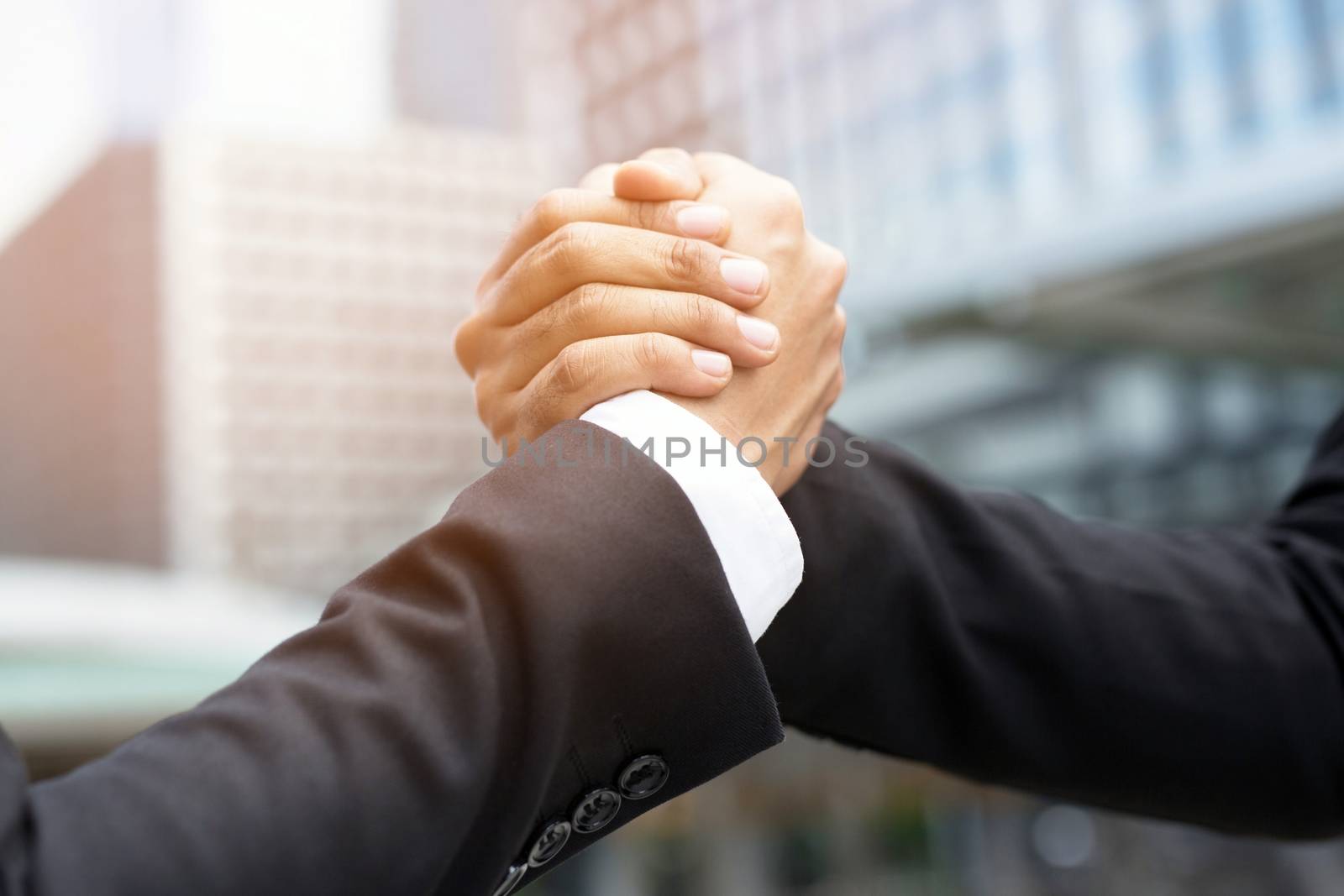 companionship hand clasping success trust, confident concept. or Closeup of a businessman hand between two colleagues on outdoor building. by boytaro1428@gmail.com