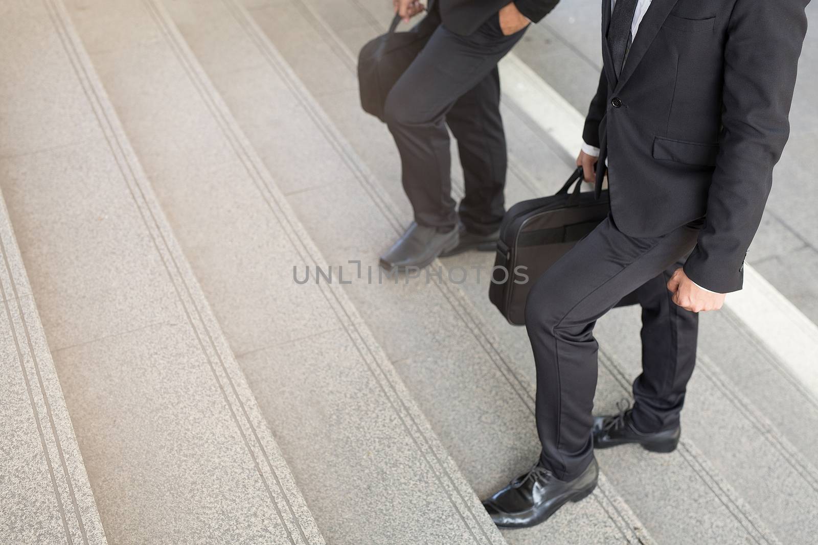 Businessman two people walking upstairs ,Fighting against obstacles Climb up to Successful finish we will walk together concept